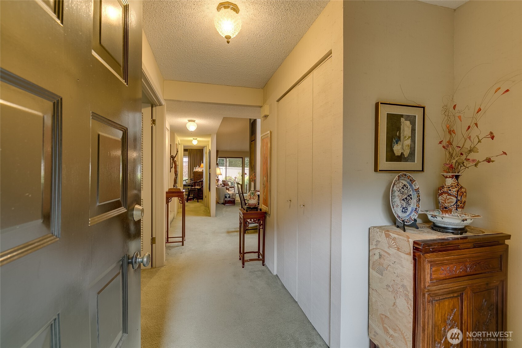 Entry leading to hallway with Den on left & fam room on right