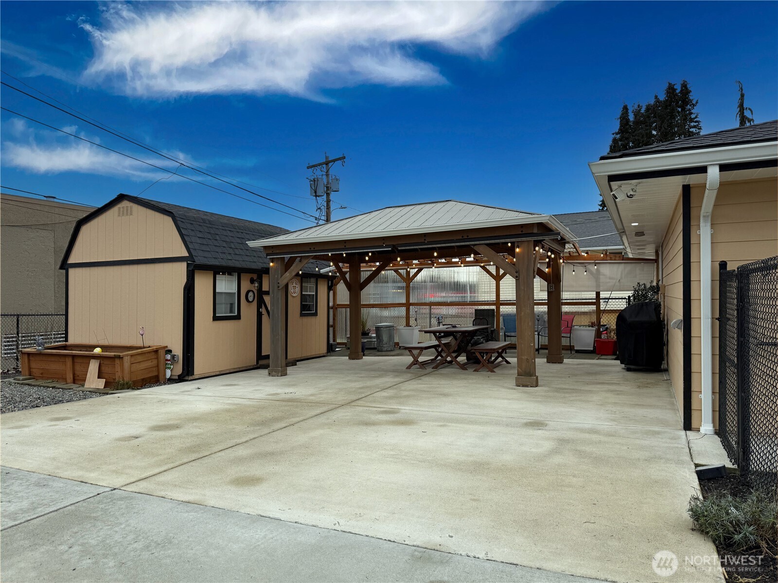 Oversized driveway with gazebo, shed, greenhouse & garden area. This has a gate that closes to completely fence in this area.