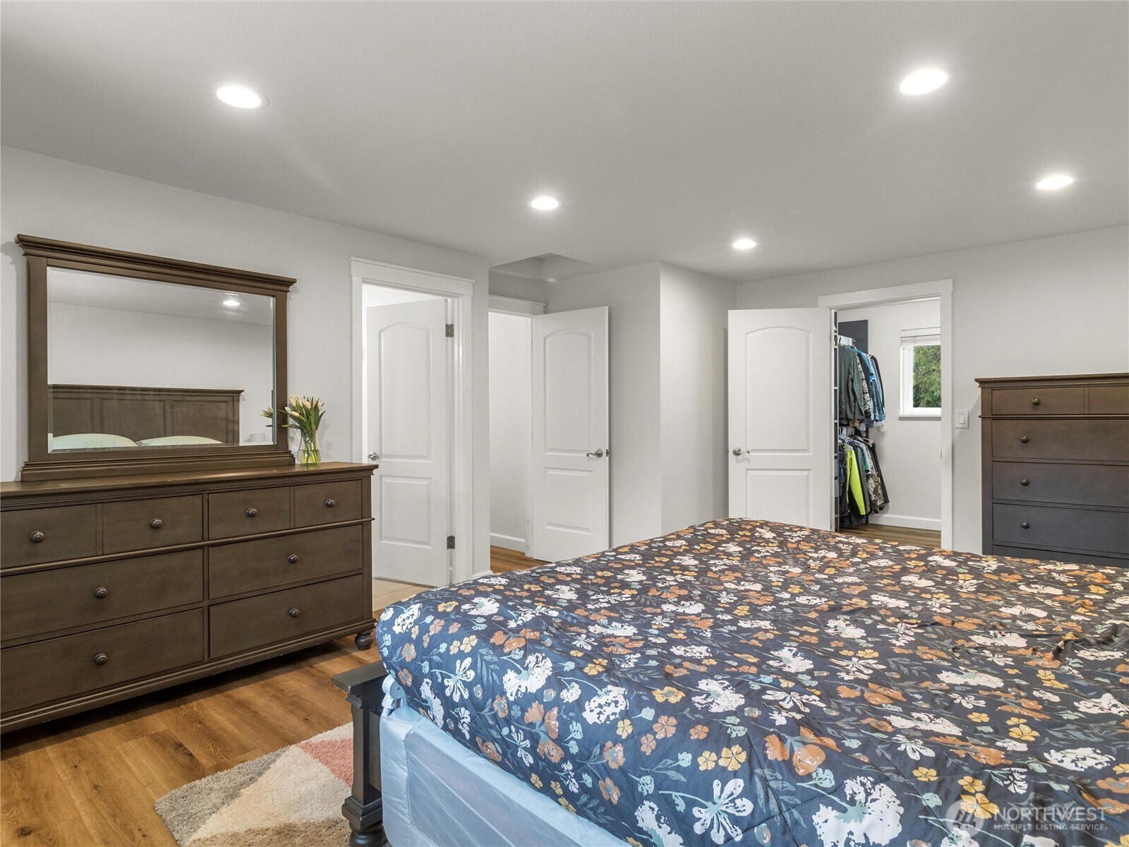 Primary bedroom with walk-in closet and ensuite bathroom.