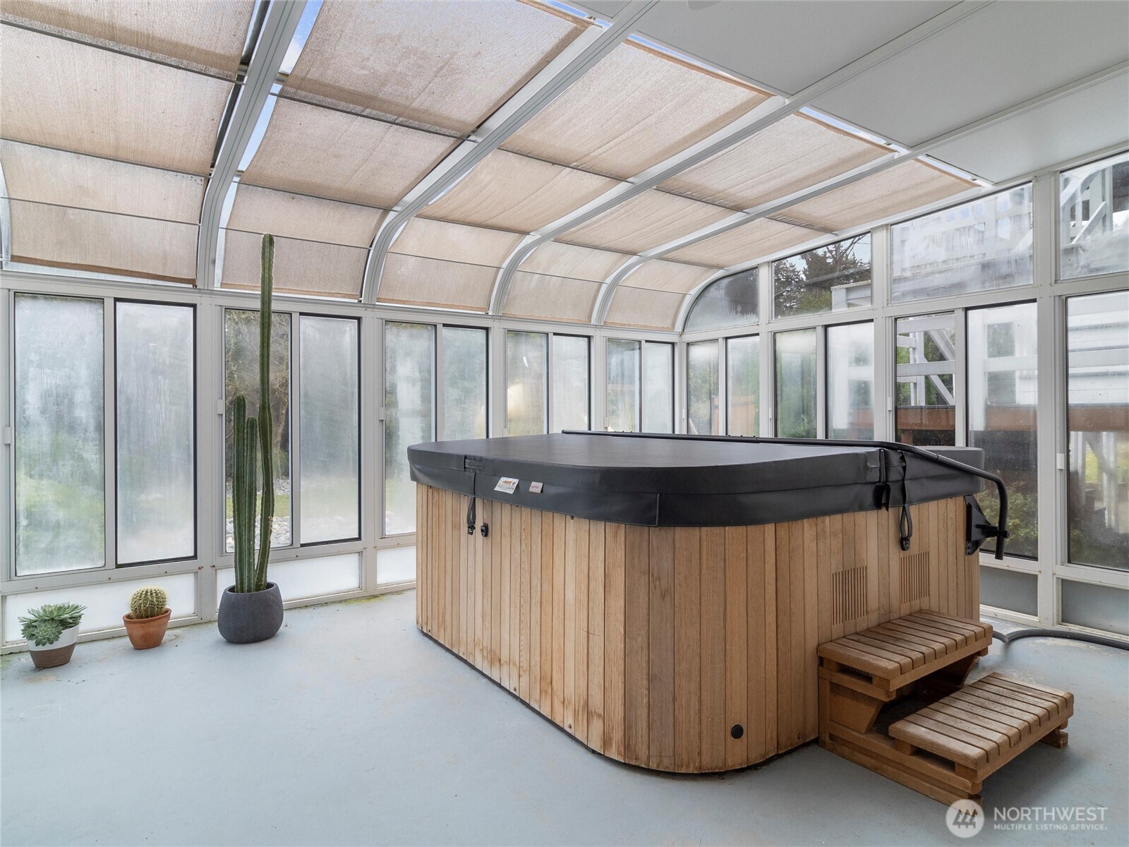 Enclosed hot tub room with floor to ceiling windows