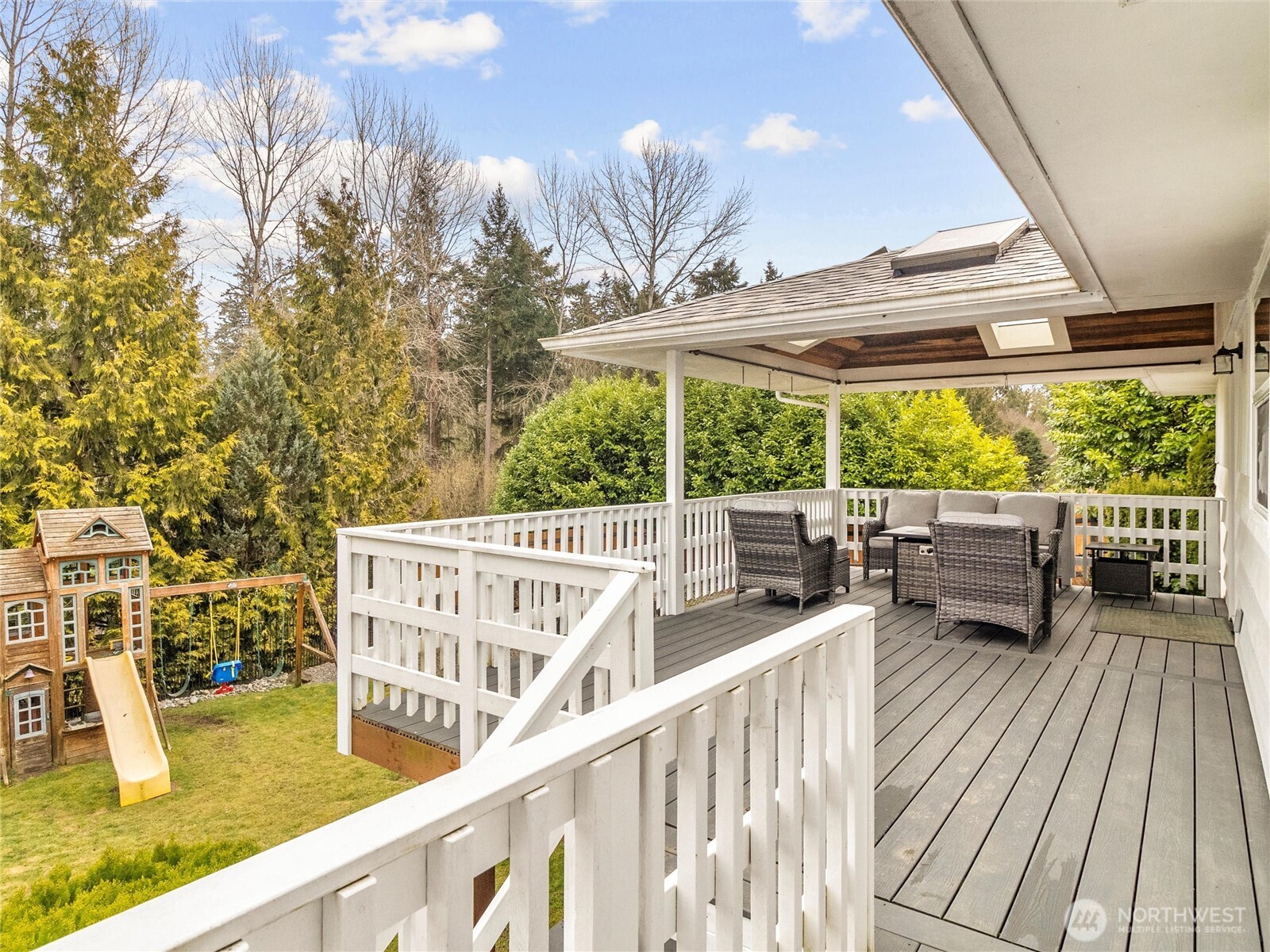 Composite backyard deck off the kitchen, with stairs leading to the yard.