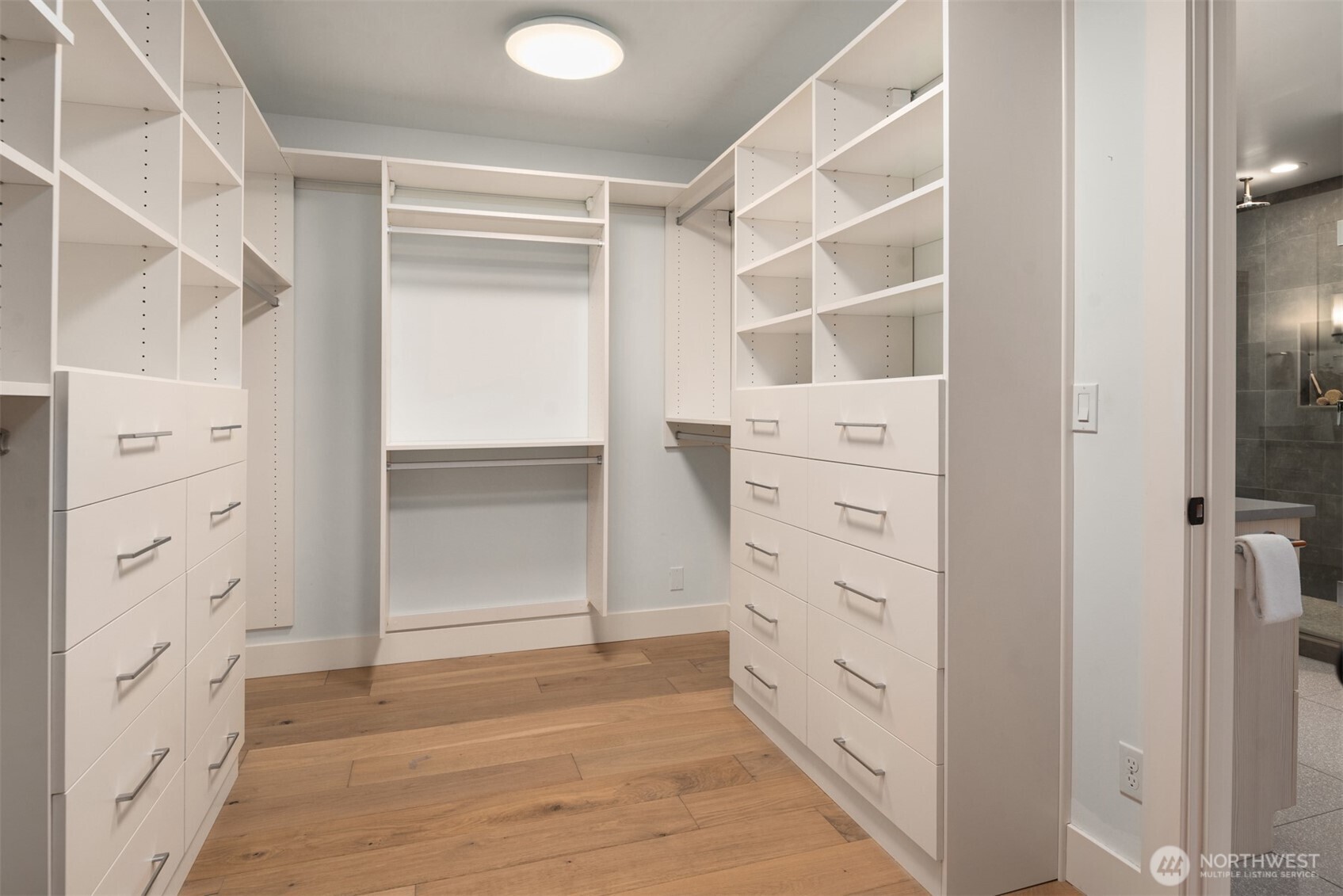 Custom primary closet with beautiful built-ins.