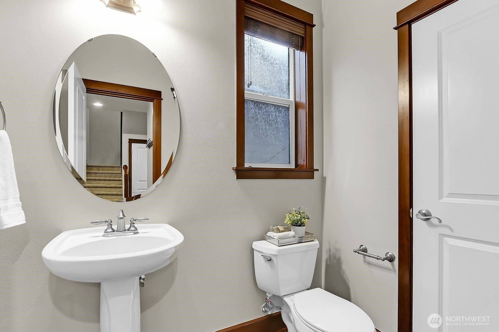 Powder room with a storage closet.