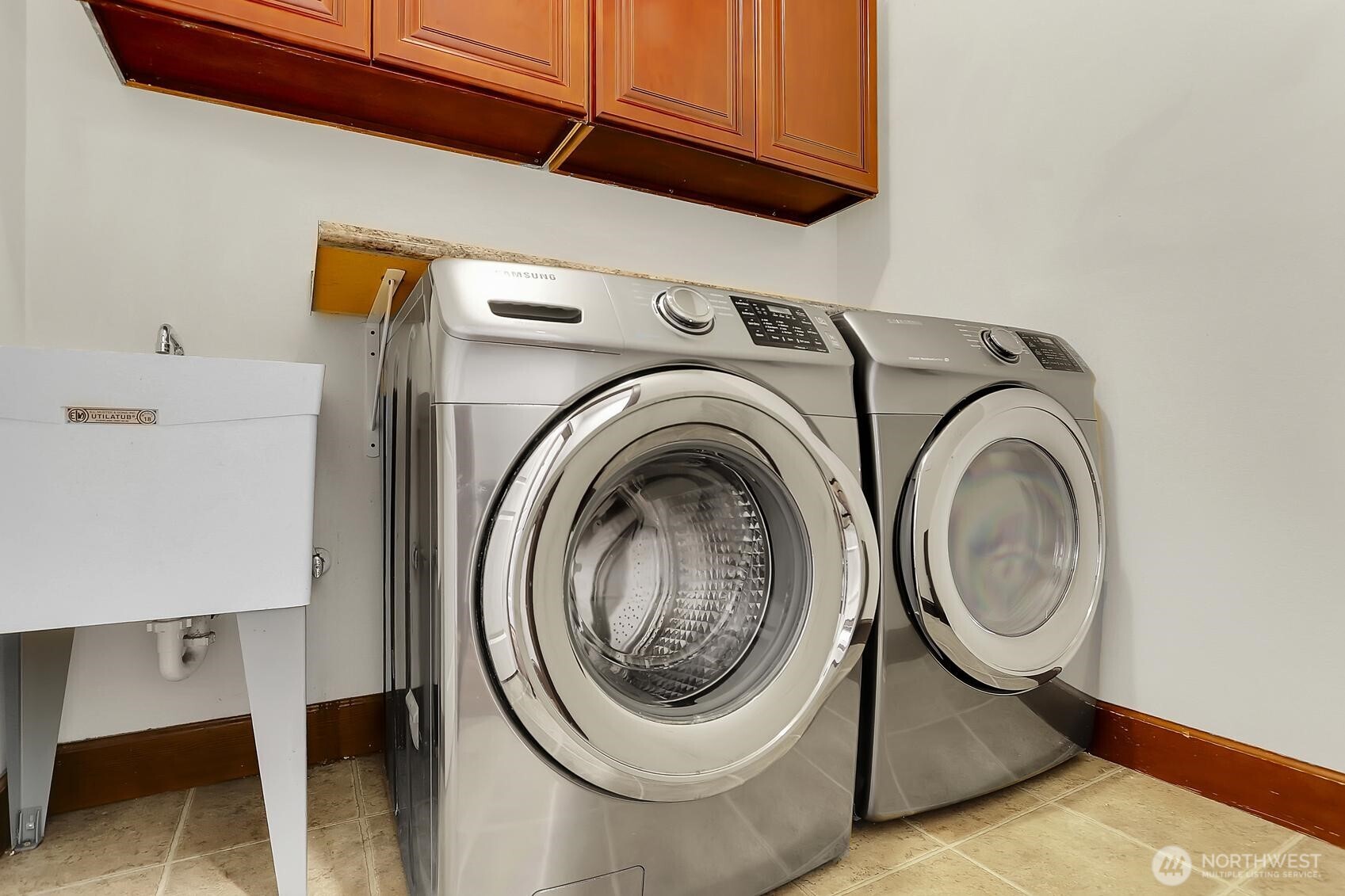 Functional utility room with a sink and ample storage space.