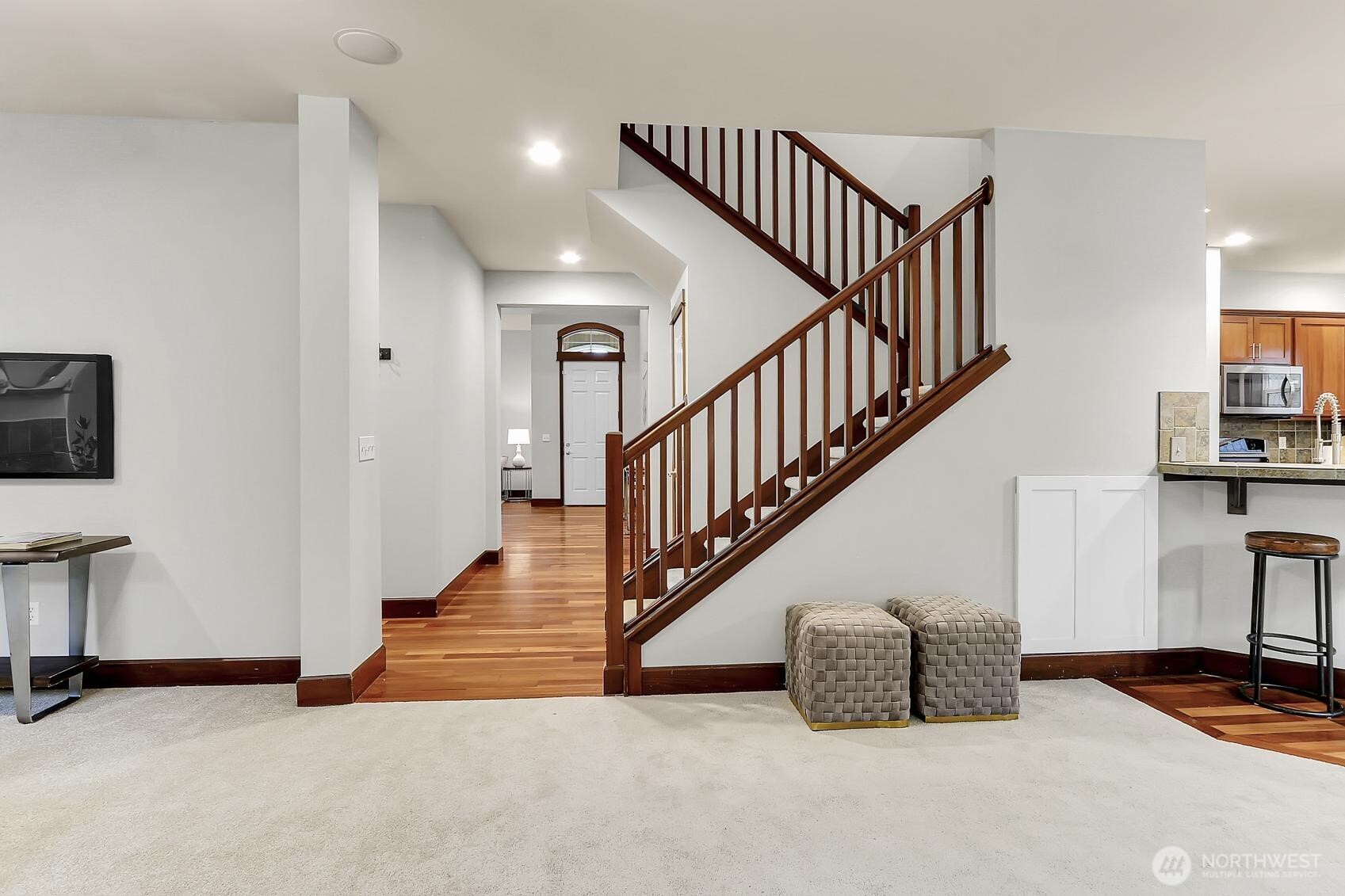 Wood-accented staircase adds warmth and charm.