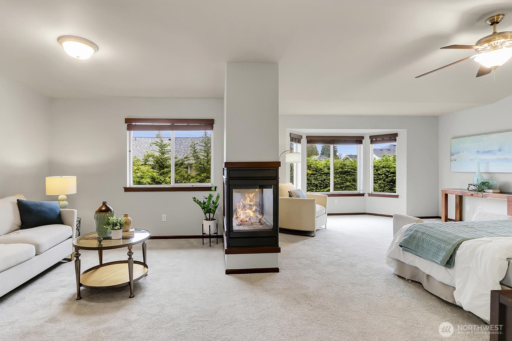 Expansive primary suite with a cozy fireplace and sitting area.