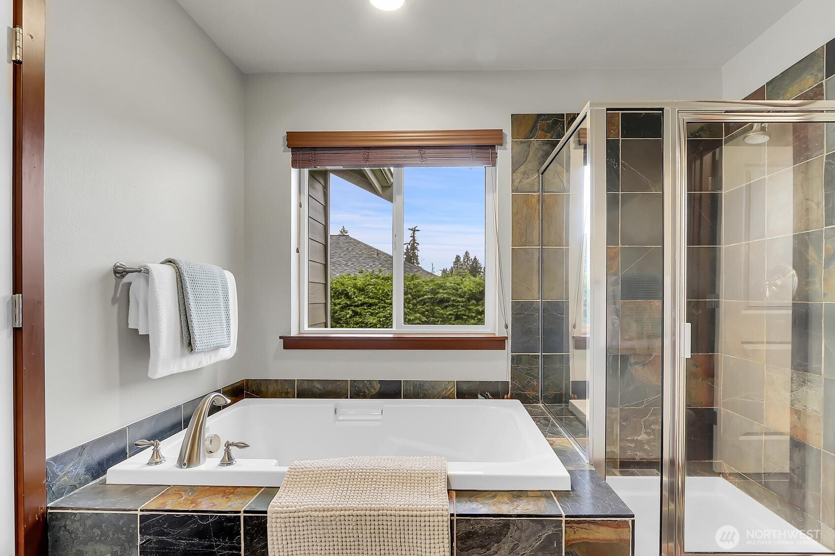 Primary bathroom with a soaking tub and separate shower.