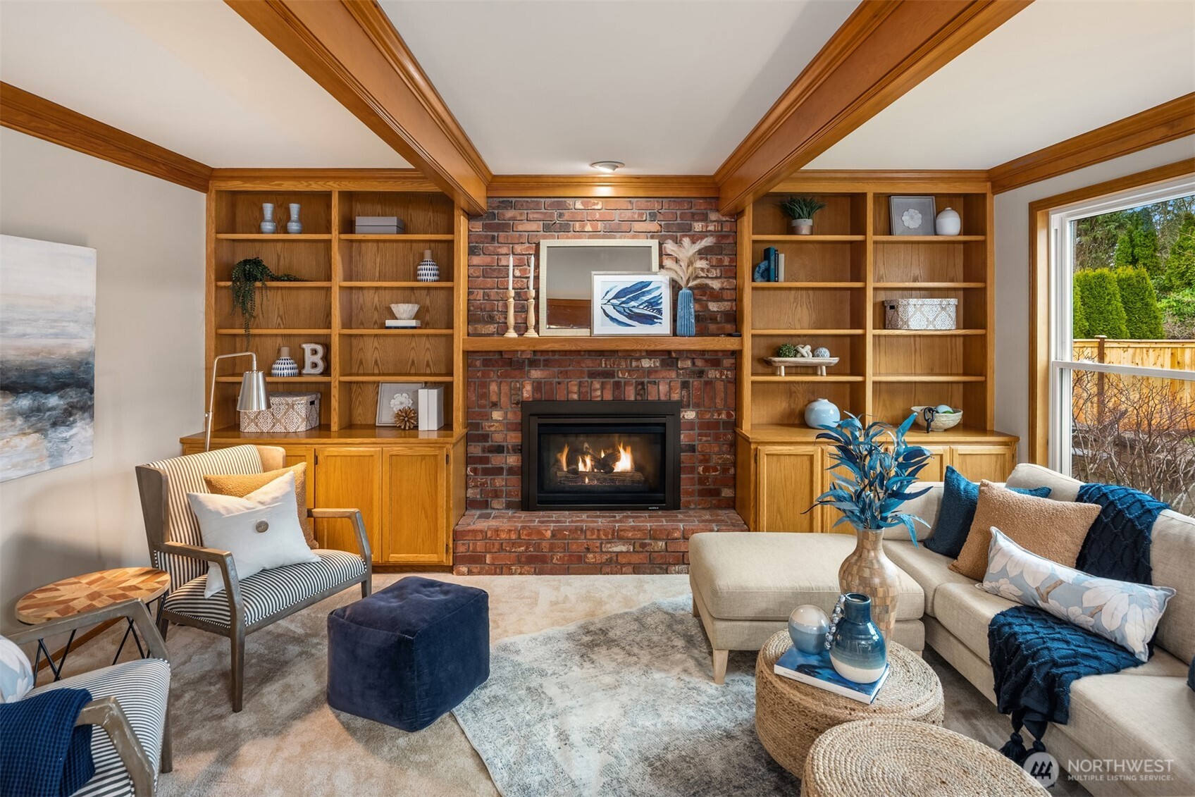 The family boasts built-in cabinets flanking a gas fireplace with remote