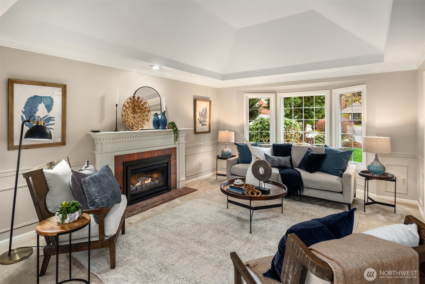 Light filled living room with coved ceiling and gas fireplace with remote.