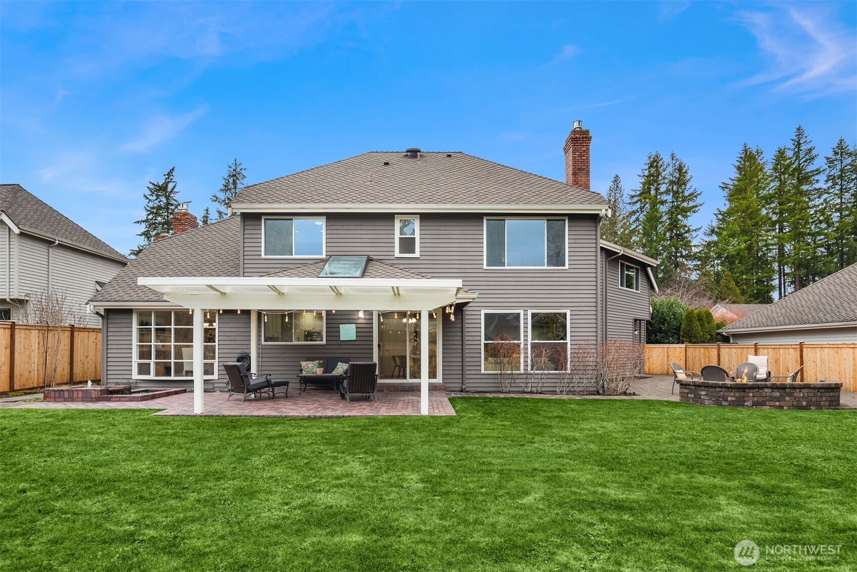 View of the back of the home and the multiple hardscape areas.