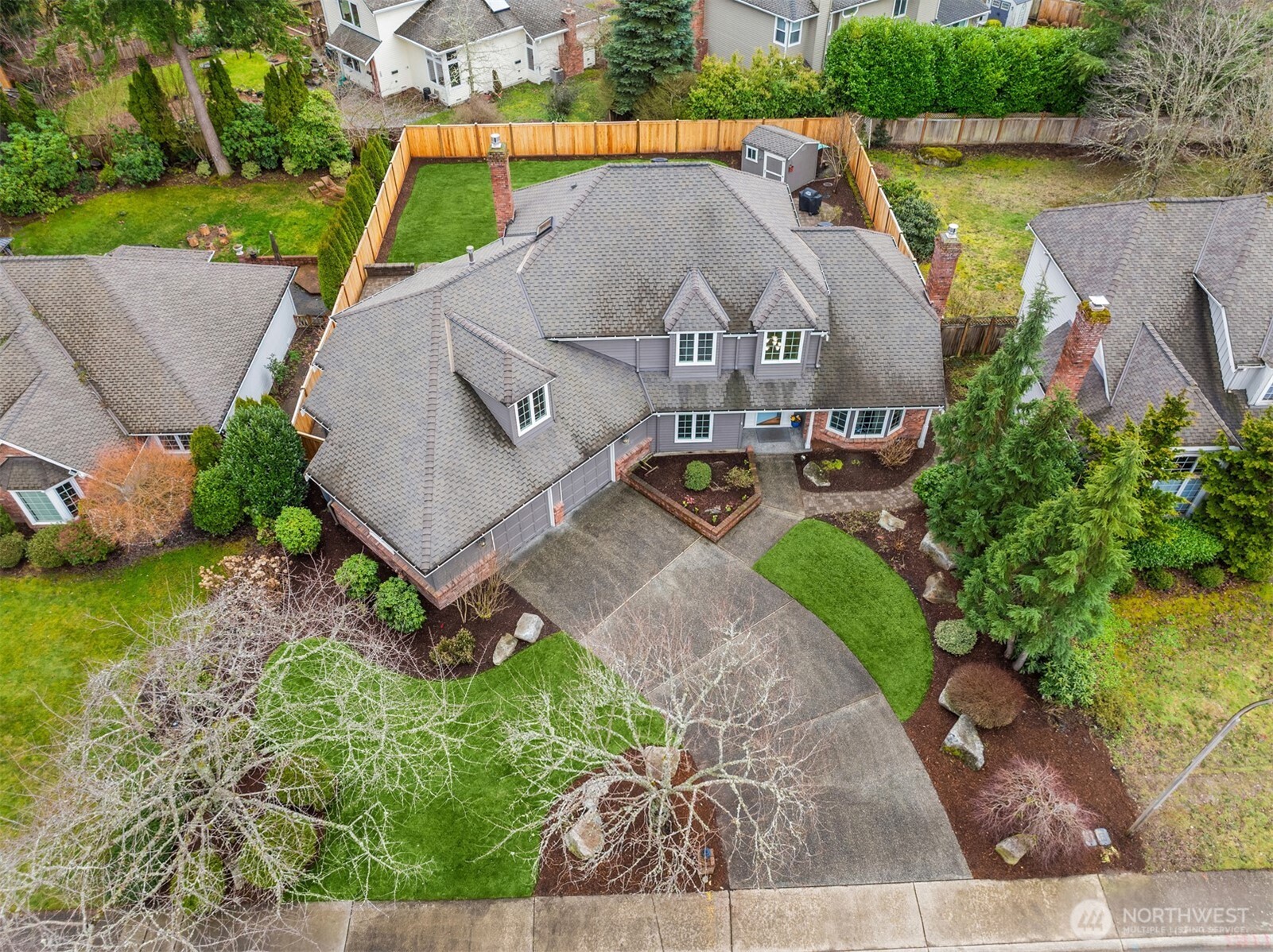 The long driveway and the cherry trees (when they have flowers) provide a stunning entrance this home.