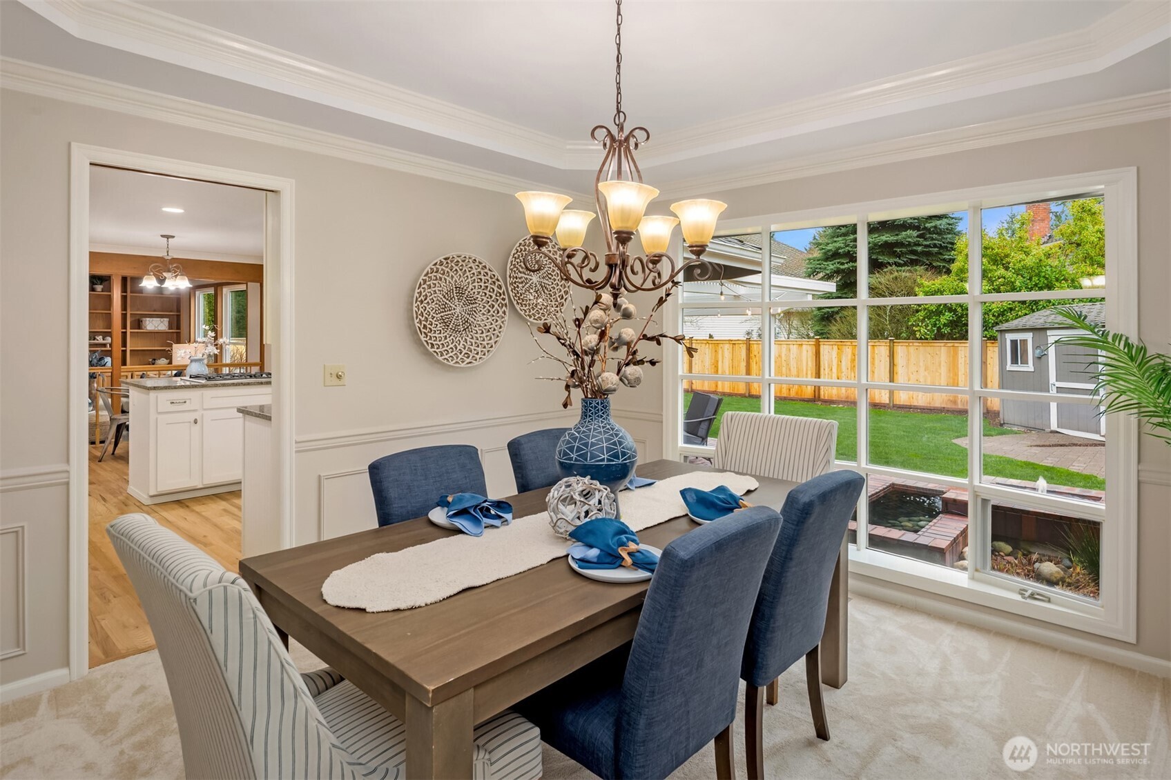 This elegant Dining Room with bow window overlooks the water feature and spacious backyard