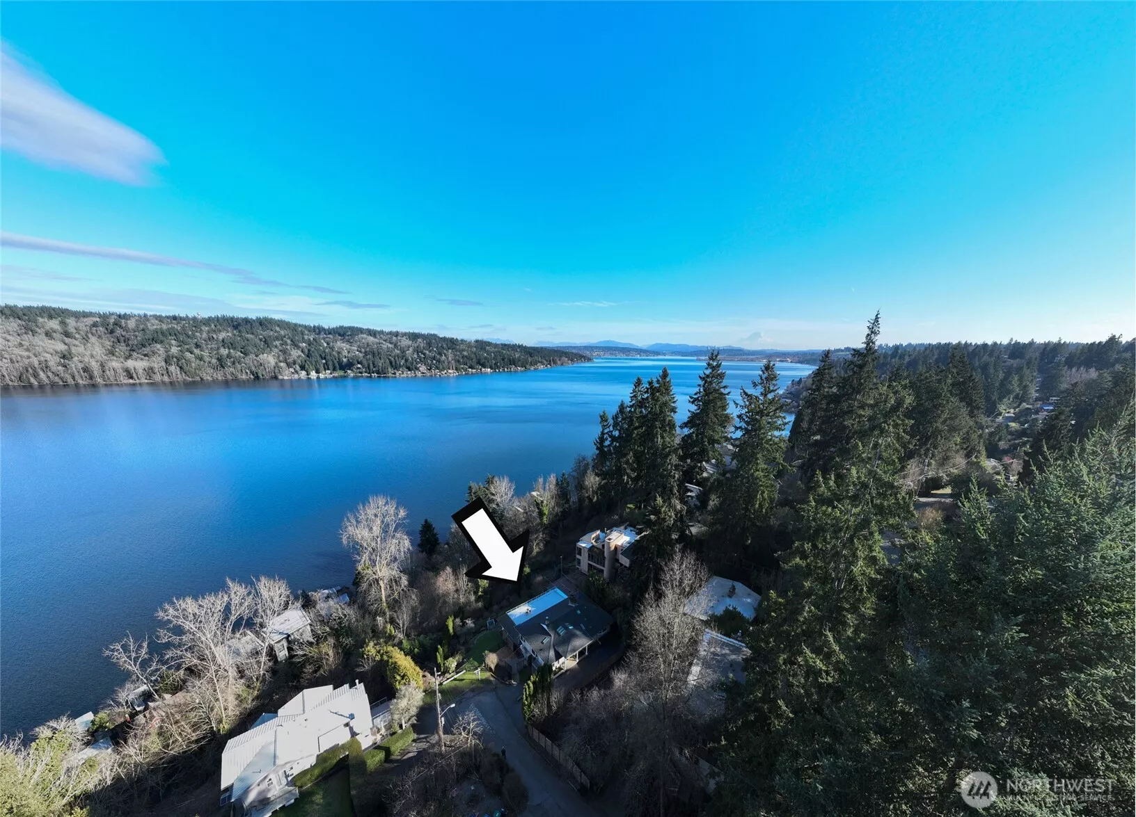 Welcome to your nearly waterfront home perched above glistening Lake Washington nestled on 1/2 Acre!