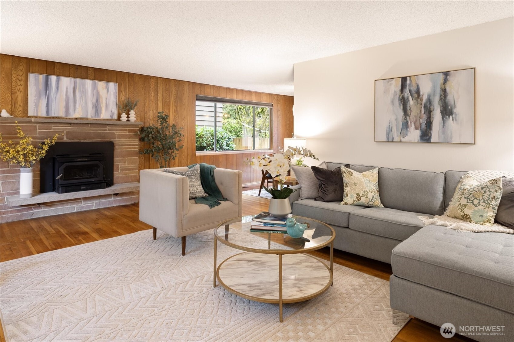 The large livingroom with fireplace and hard wood floors.