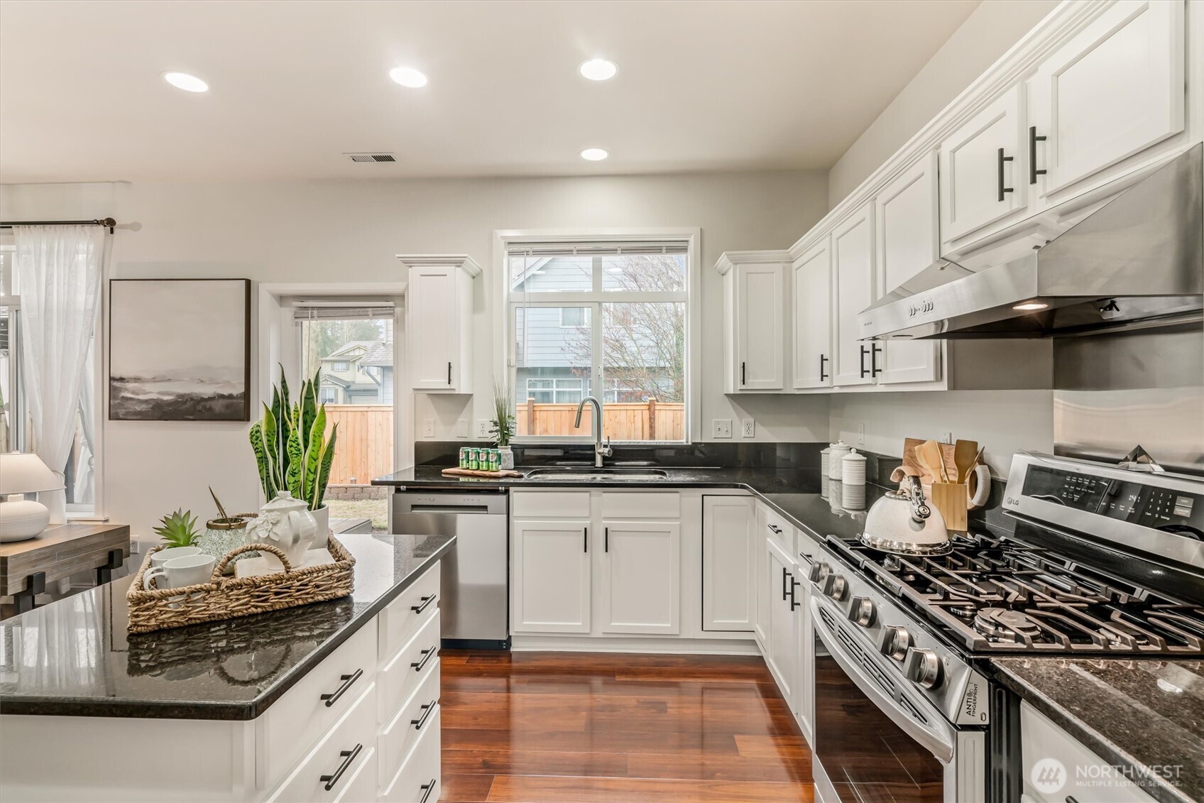 Gas cooktop and stainless steel vent hood are a chef's dream!