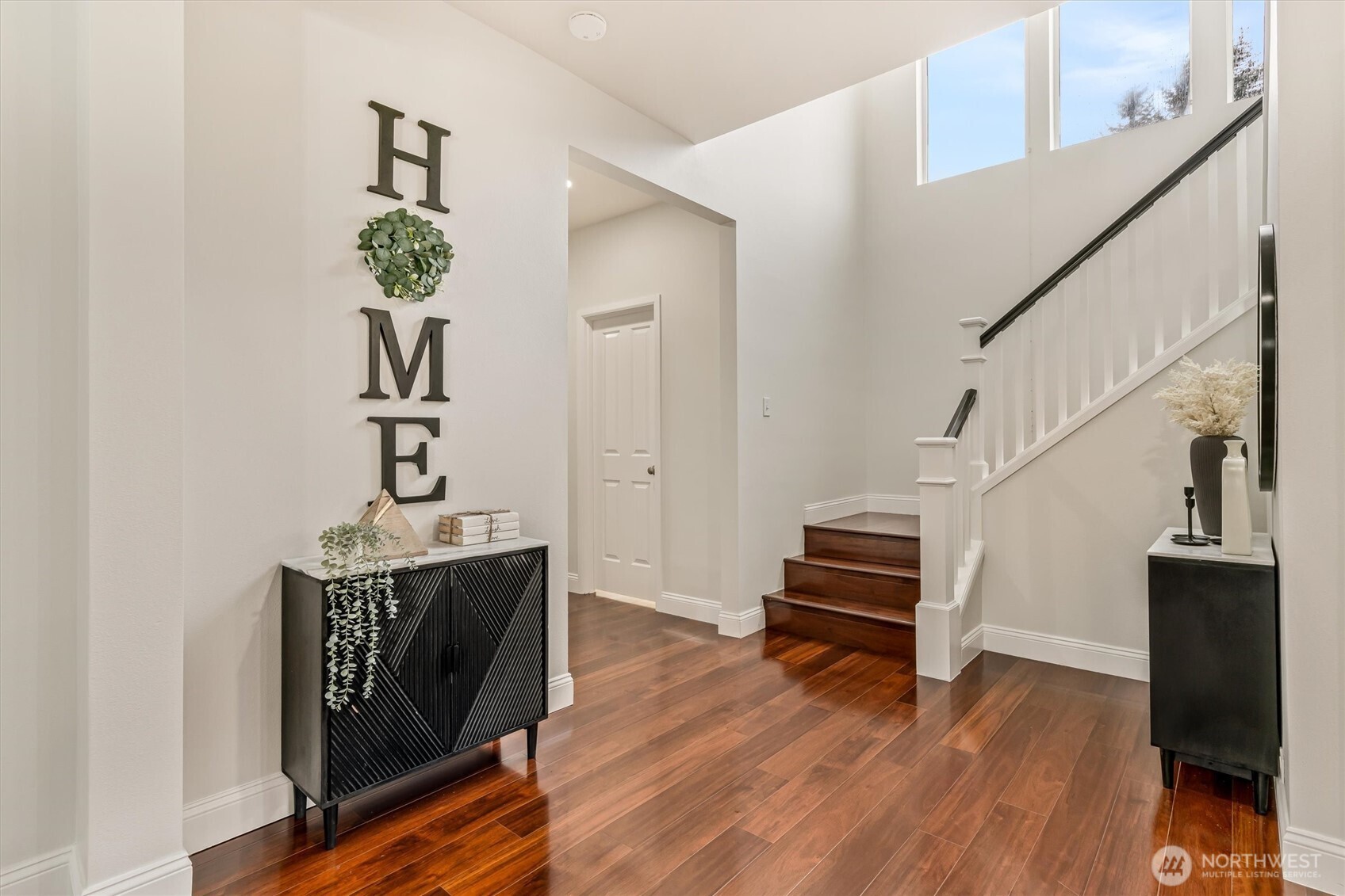 Dramatic hardwood flooring up the stairs provide additional touch of class