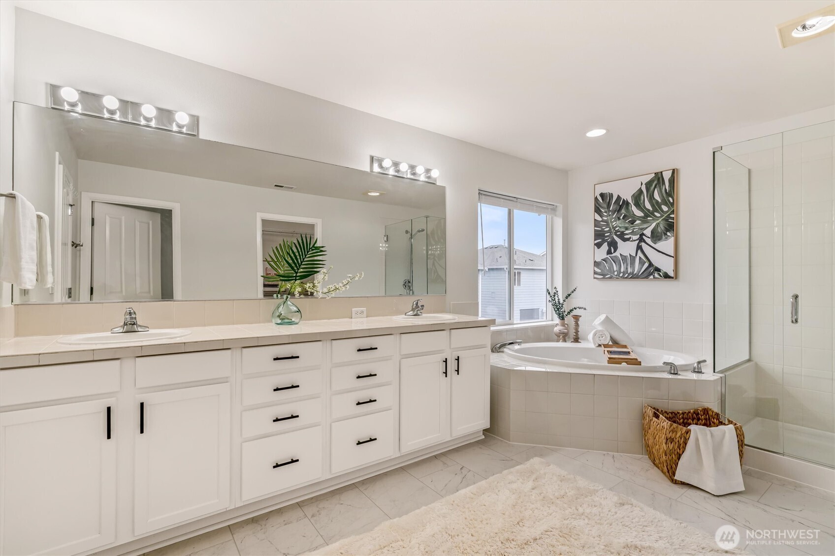 Dual sinks, deep soaking tub and tile shower offers a sense of comfort and relaxation