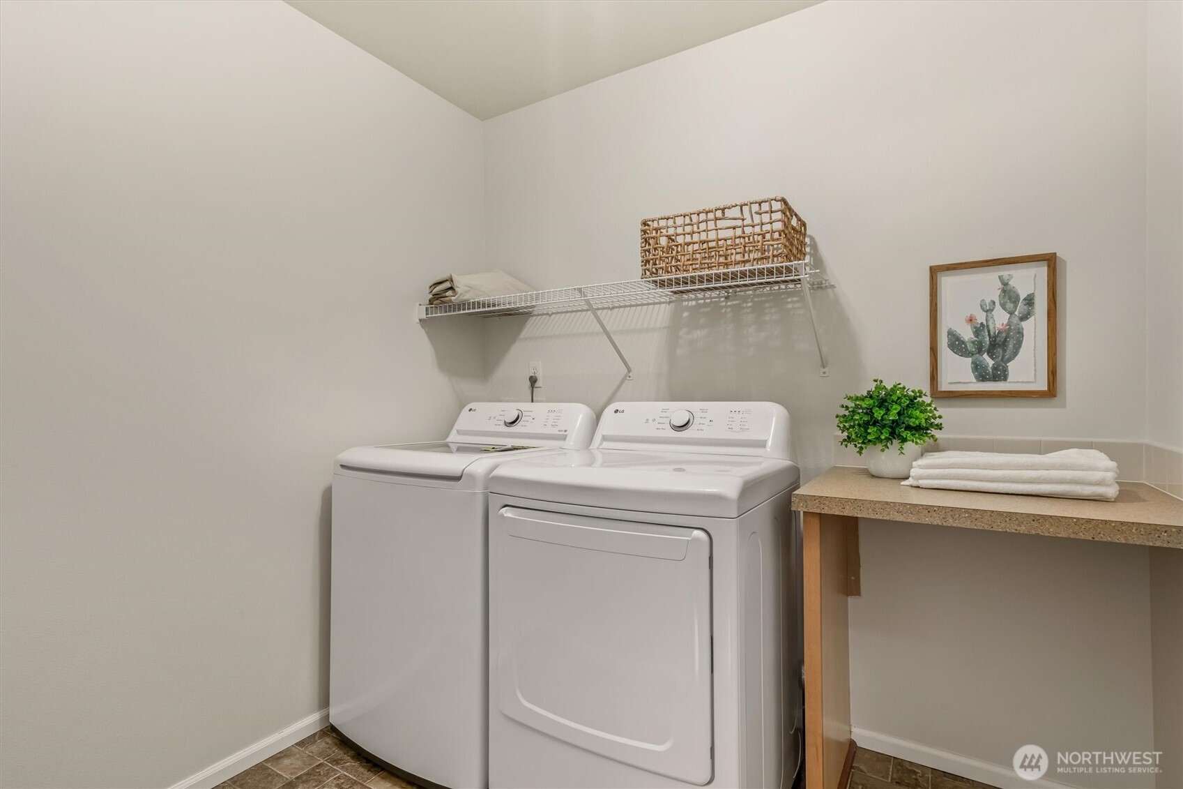 Laundry room provides plenty of work space and storage.