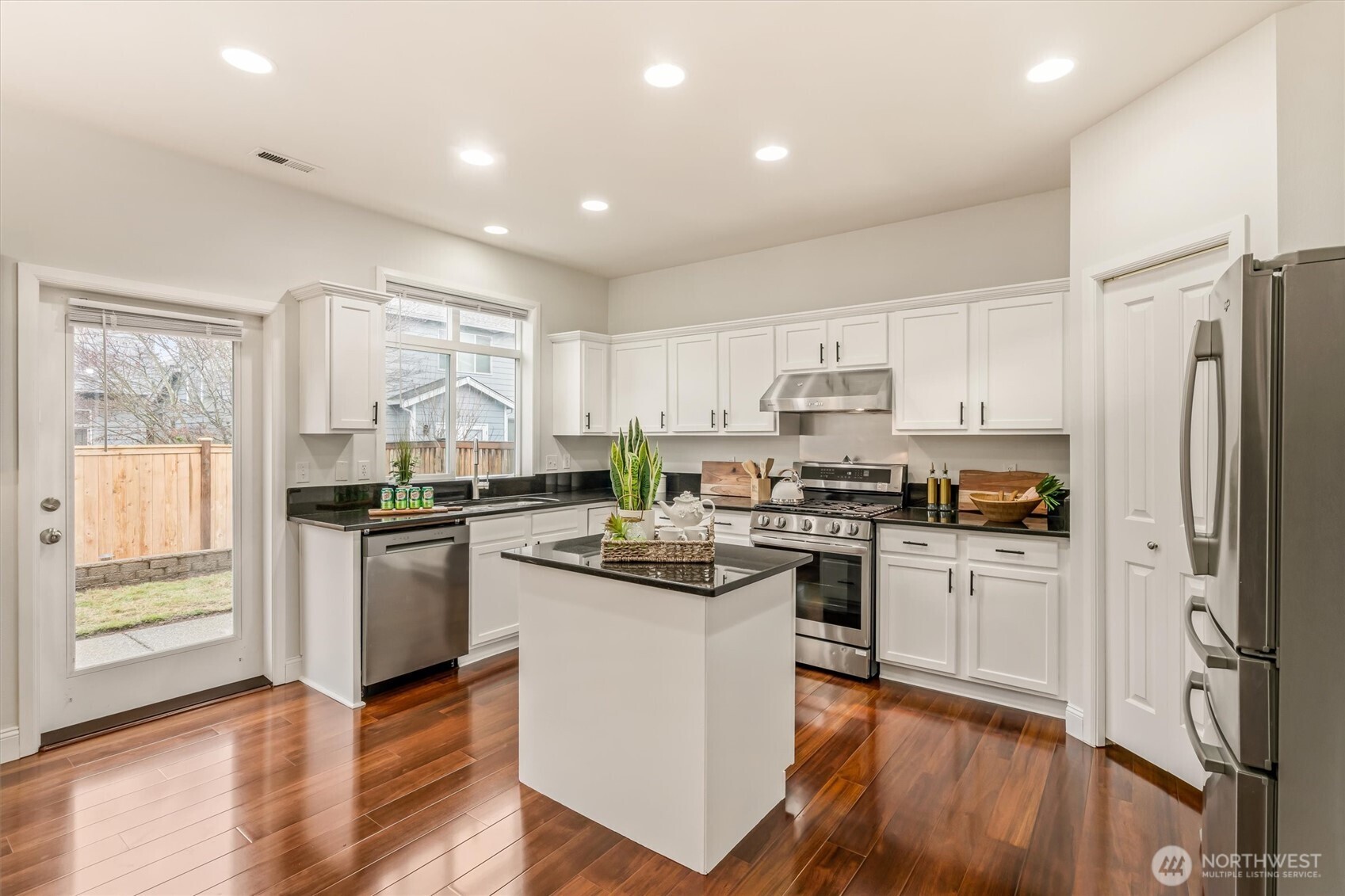 Stainless steel appliances and quartz countertops finish off this great kitchen!