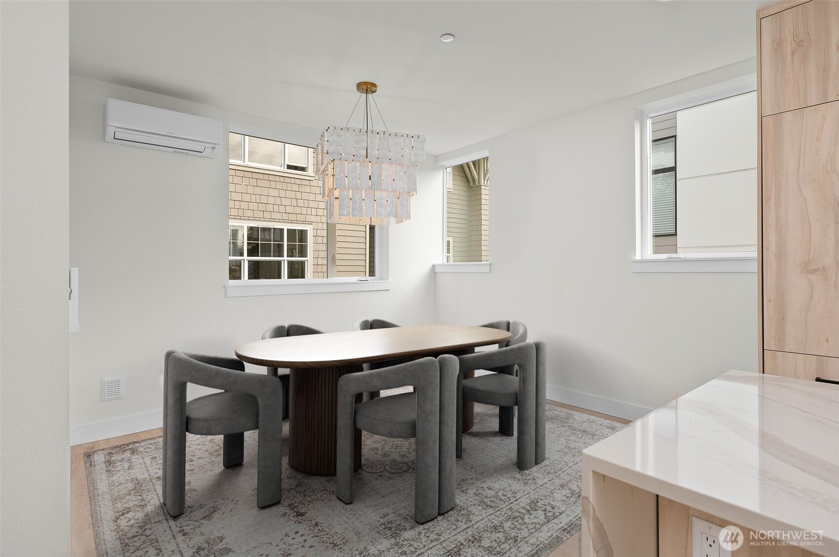 Boasting an elongated floating island, this bright kitchen features breakfast bar seating, flush refrigerator, and tasteful green backsplash.