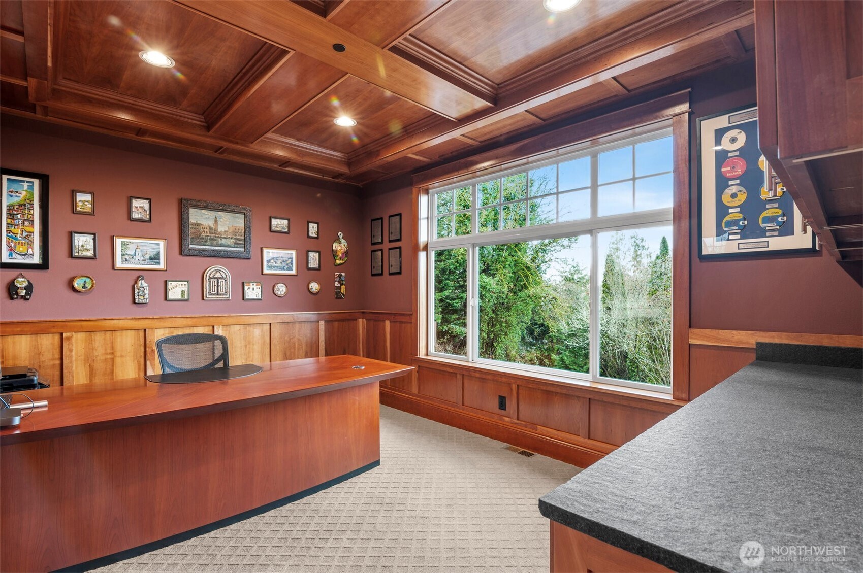 Main floor stylish office with built-ins and box beam ceiling, perfect for work from home.