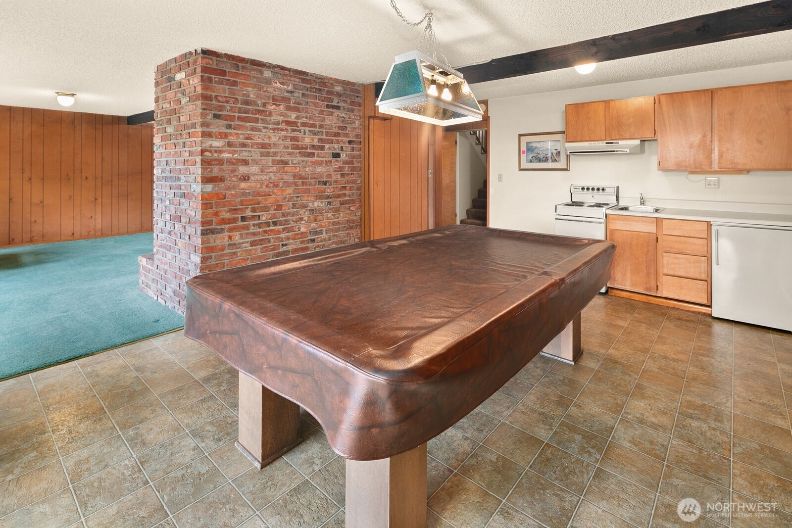 On the other side of the second fireplace, you have a handy kitchenette and this pool table (which stays with the home) - ready for game nights!