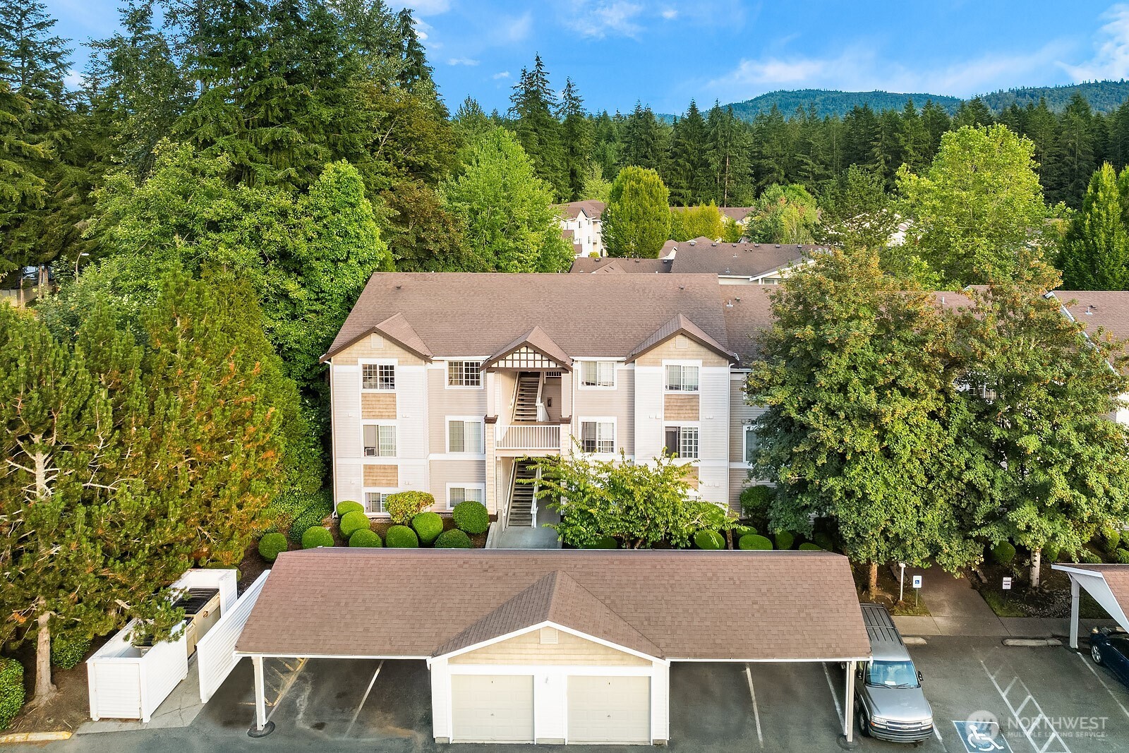 Top floor end unit with covered parking space right in front.