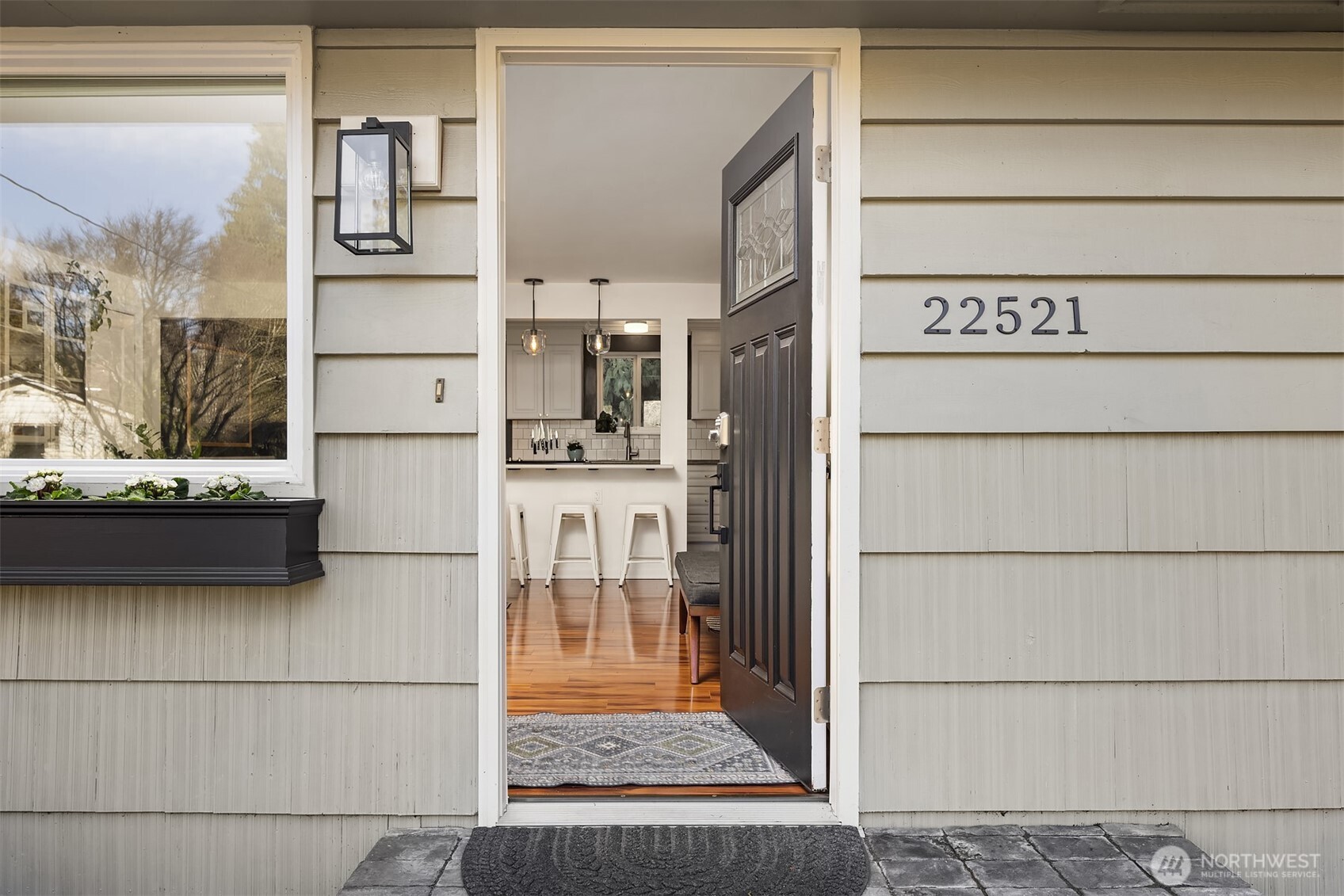 A stone walkway leads to an inviting entry with modern touches leading to a bright, open concept interior.