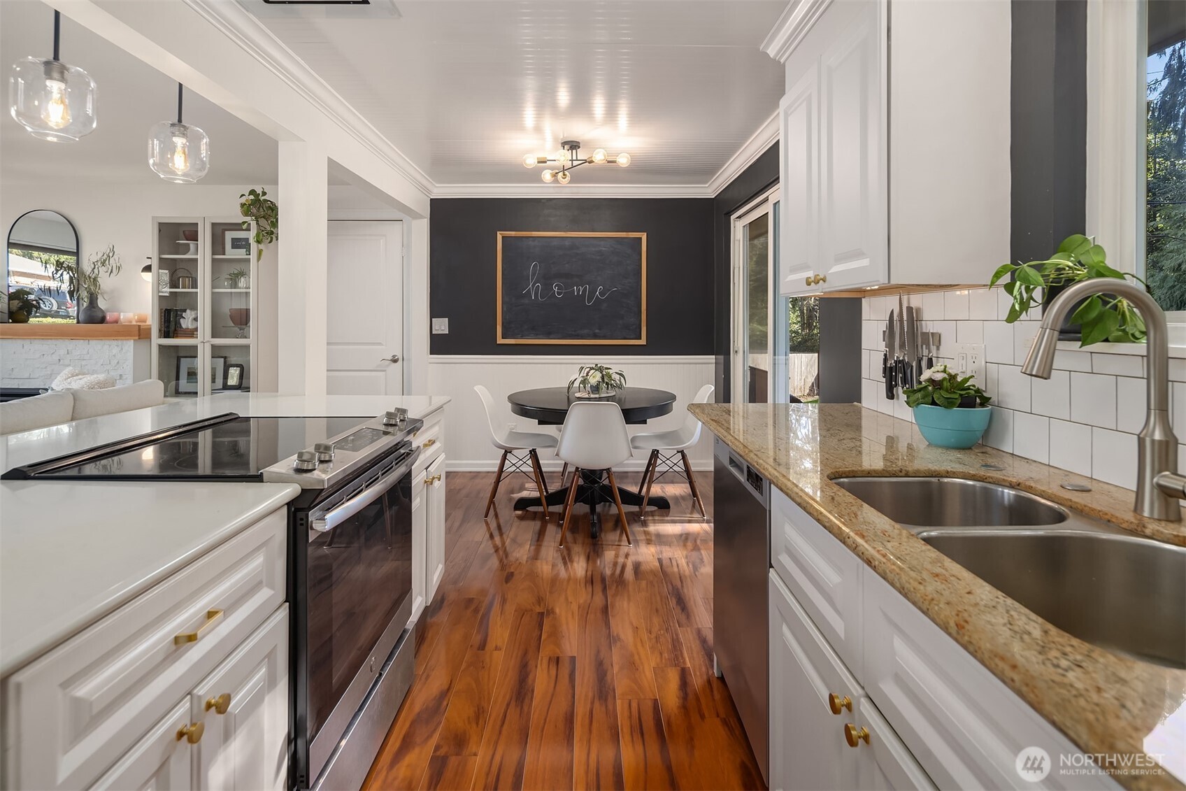 Kitchen with view of the dining area and door access to garage.