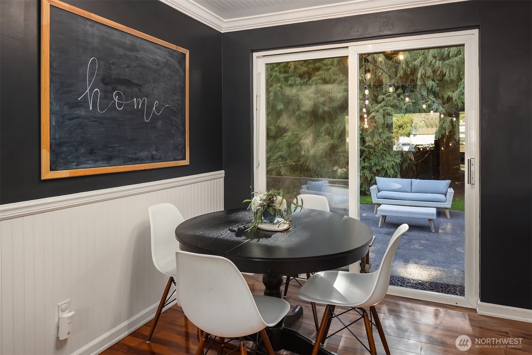 Dining area with access to outdoor space through sliding door.