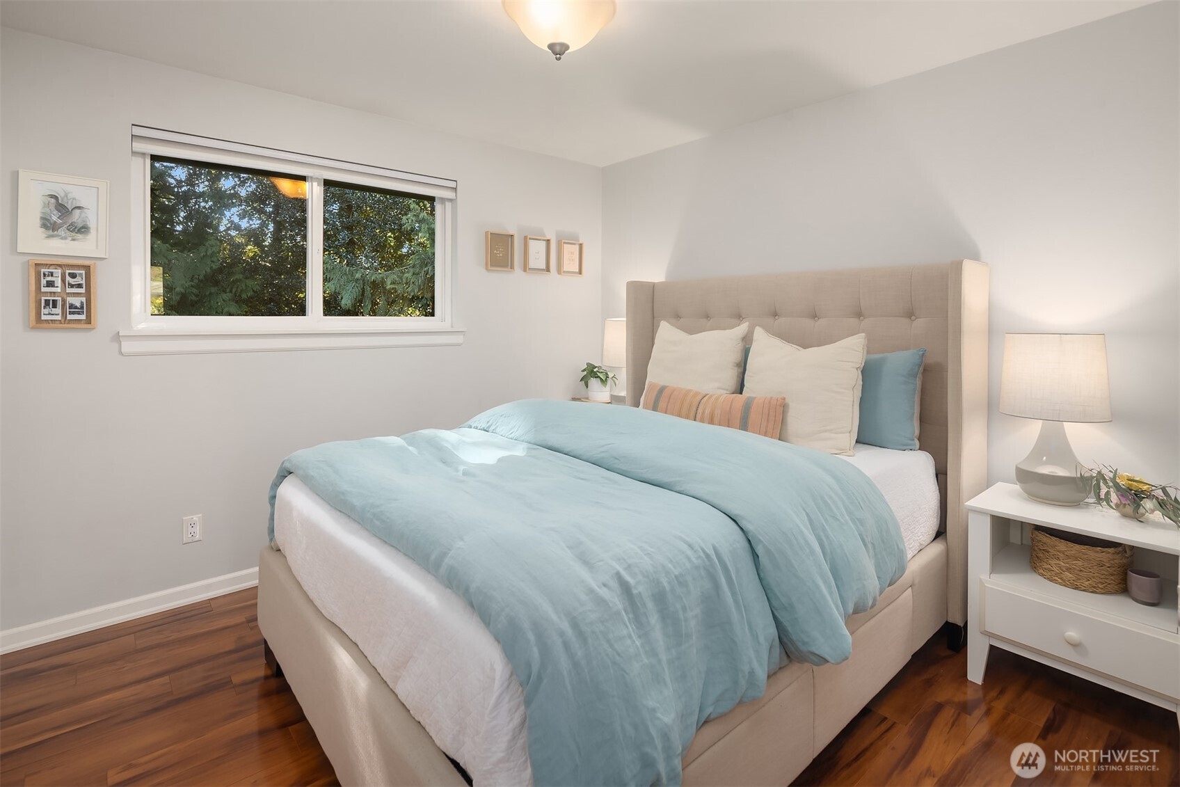 Bedroom with large window bringing in natural light.