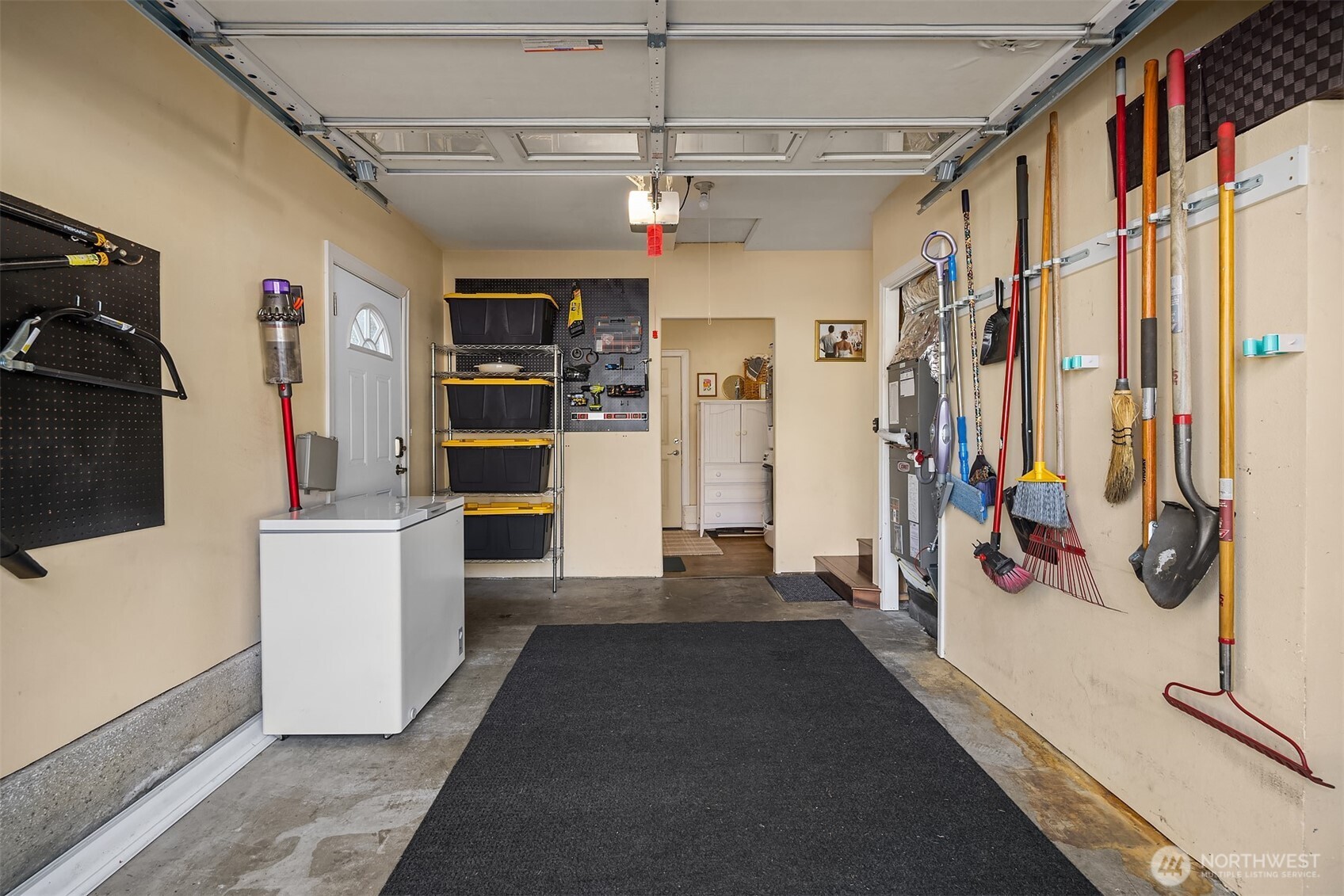 Garage with storage space and access to laundry/office area.