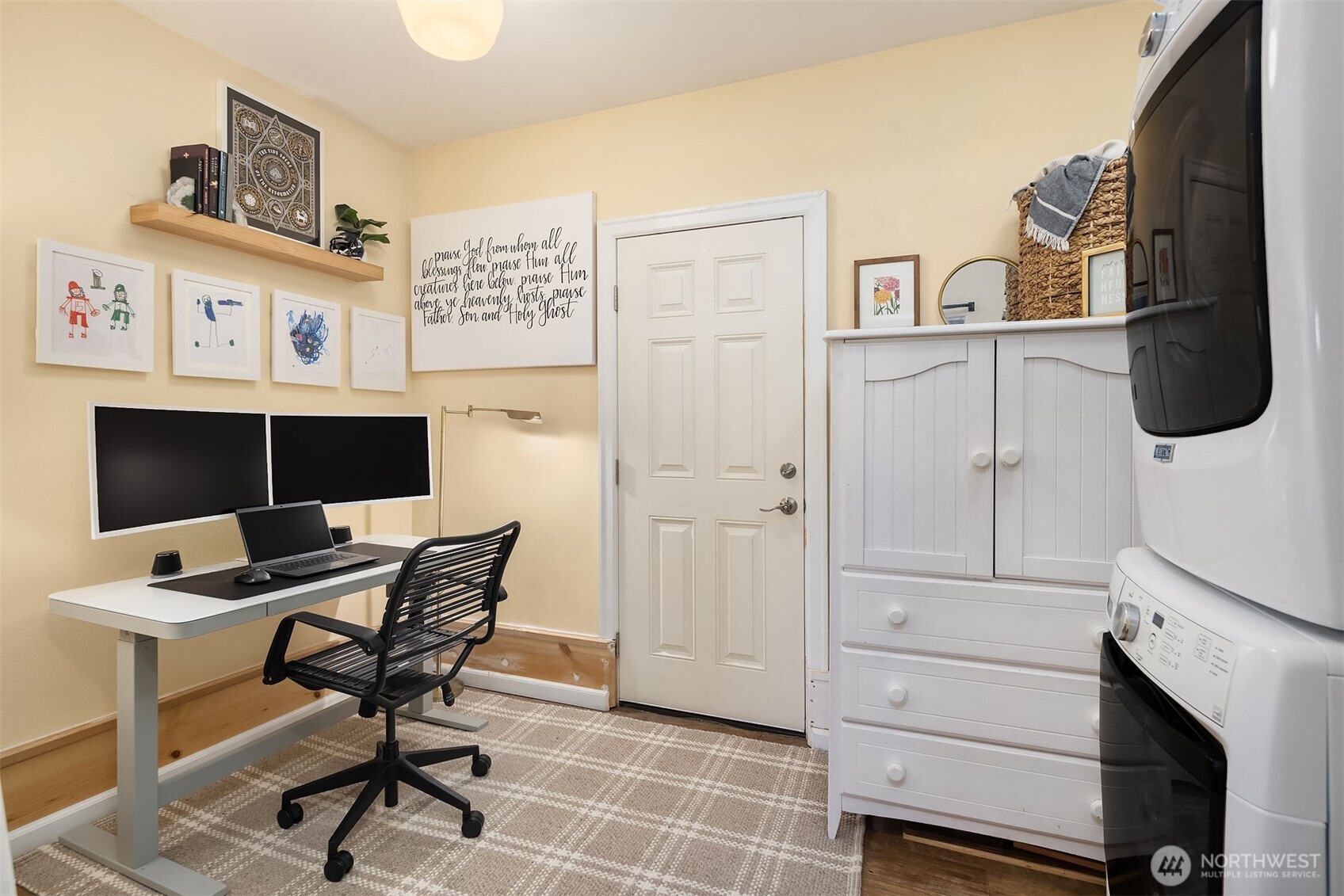 Versatile space featuring home office set up and nearby laundry area.