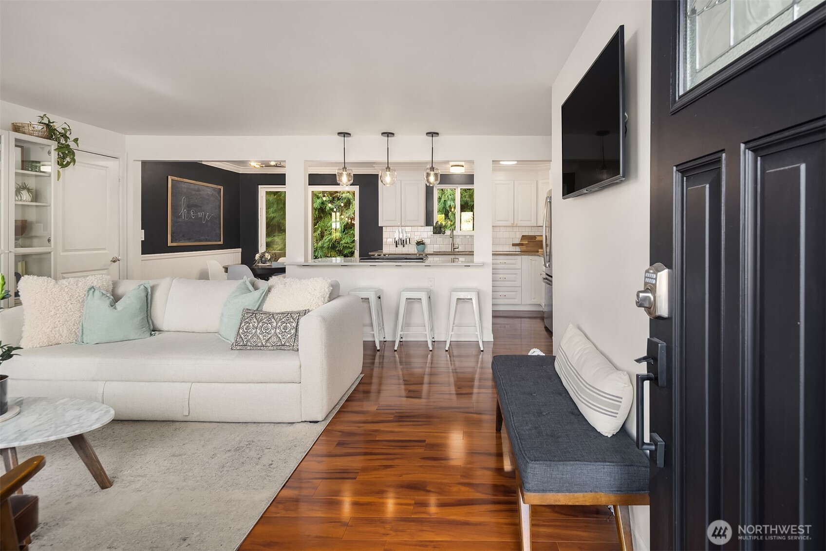 The entryway flows into a bright and modern living space.