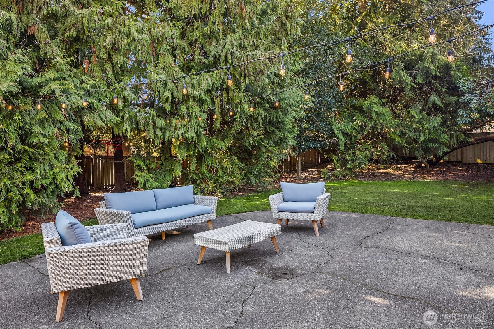 Outdoor patio surrounded by greenery.