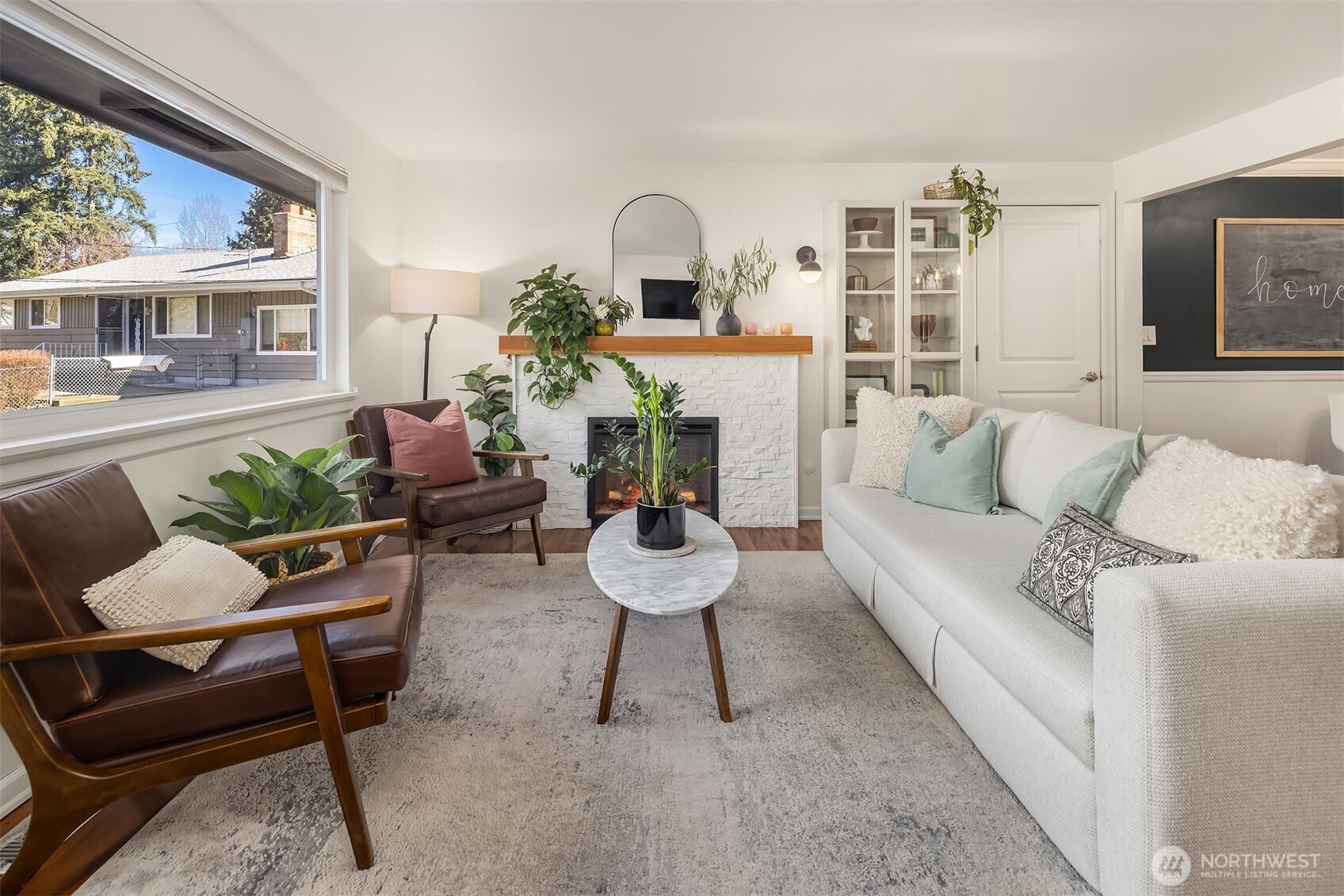 Living room with large window adding to the room’s bright and open feel.