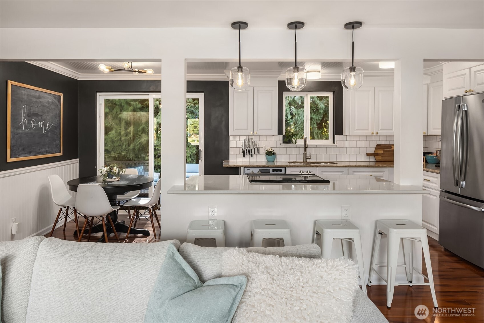 Open kitchen with clear view of dining area and natural light from surrounding windows.