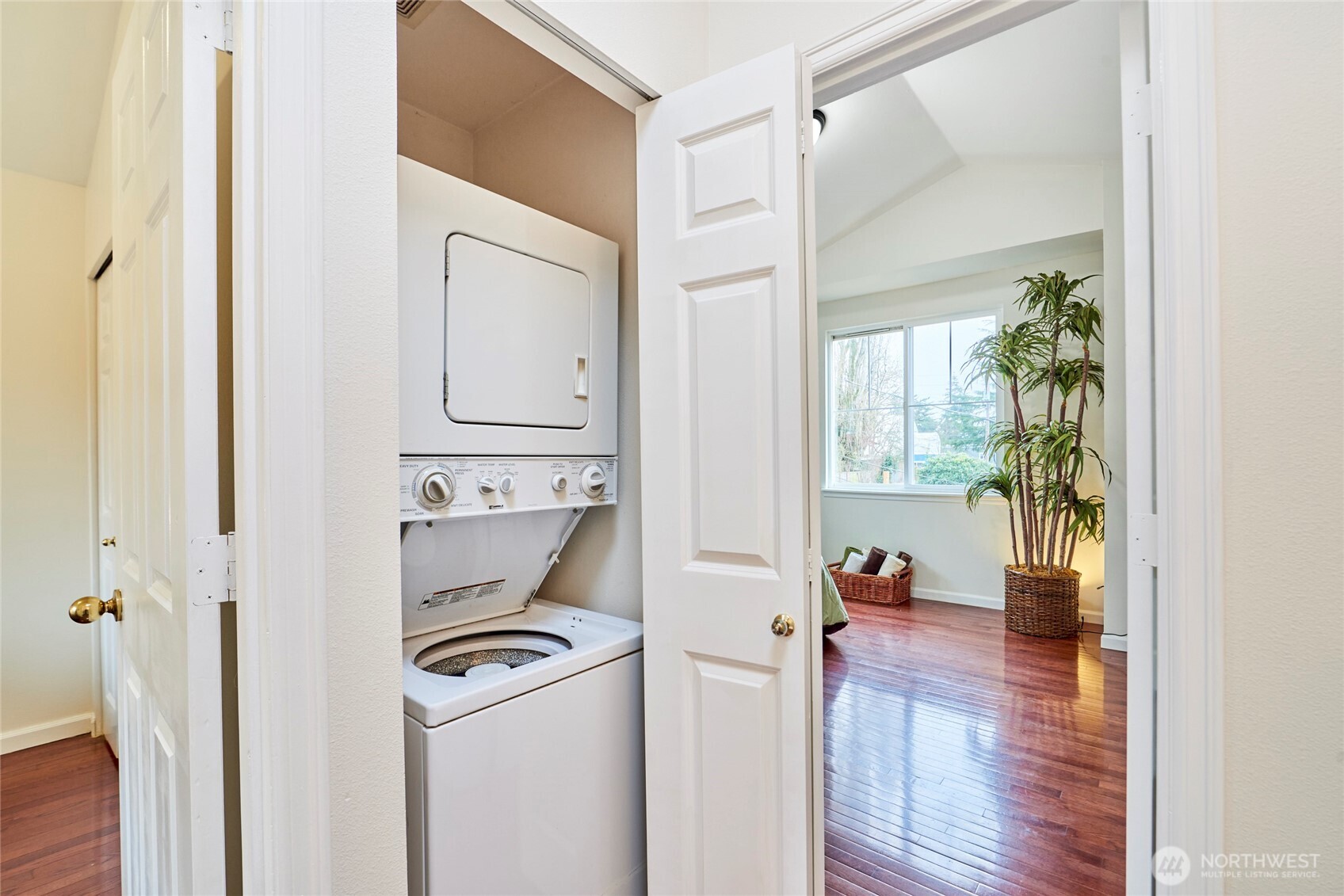 The stacked laundry in the upstairs hallway is conveniently located between the 2 bedrooms.