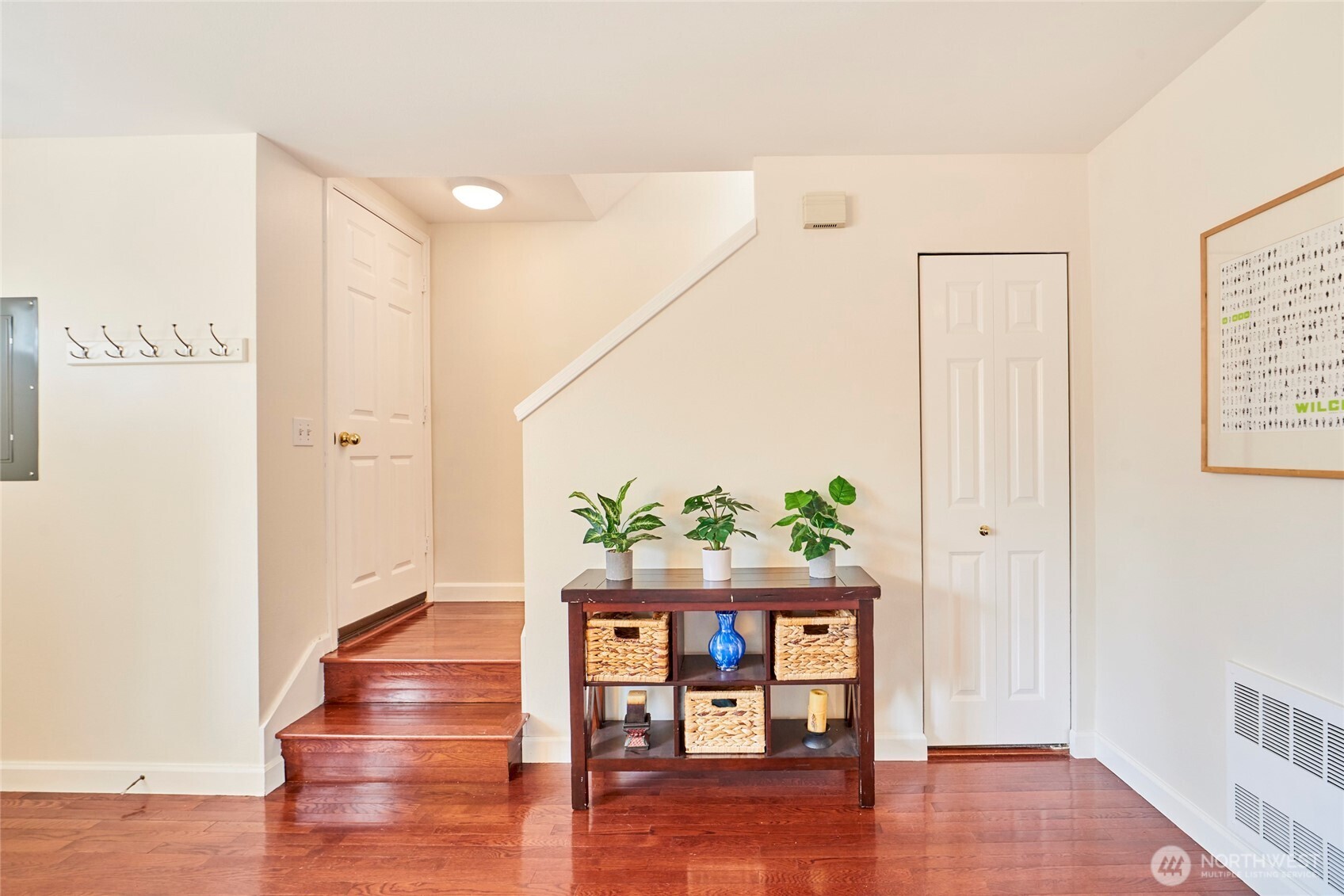 A look at the stairs. To the right is the coat/storage closet and to the left is a closet with the hot water heater and radiant heating system.