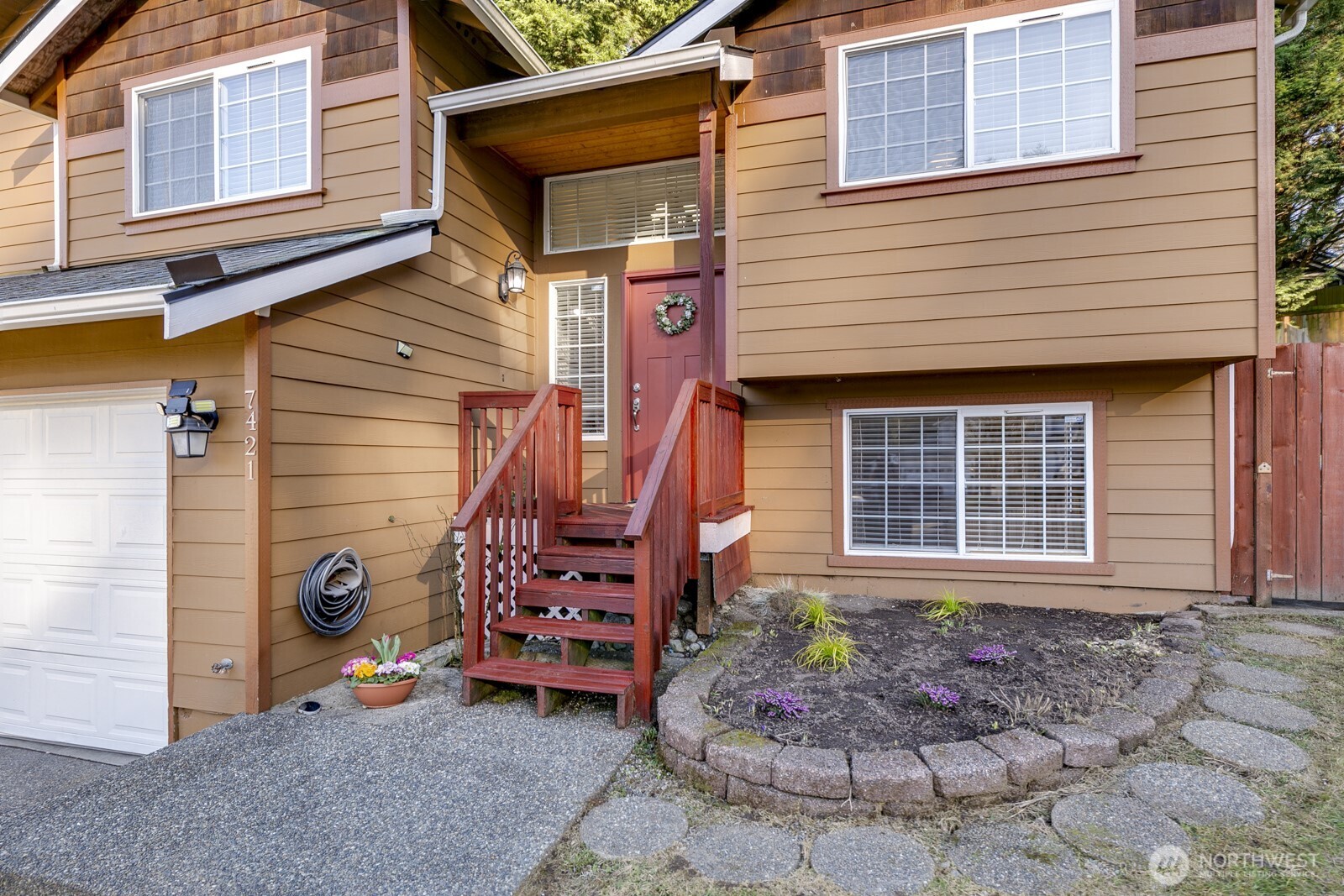 Raised garden beds and a freshly stained entry welcomes you.