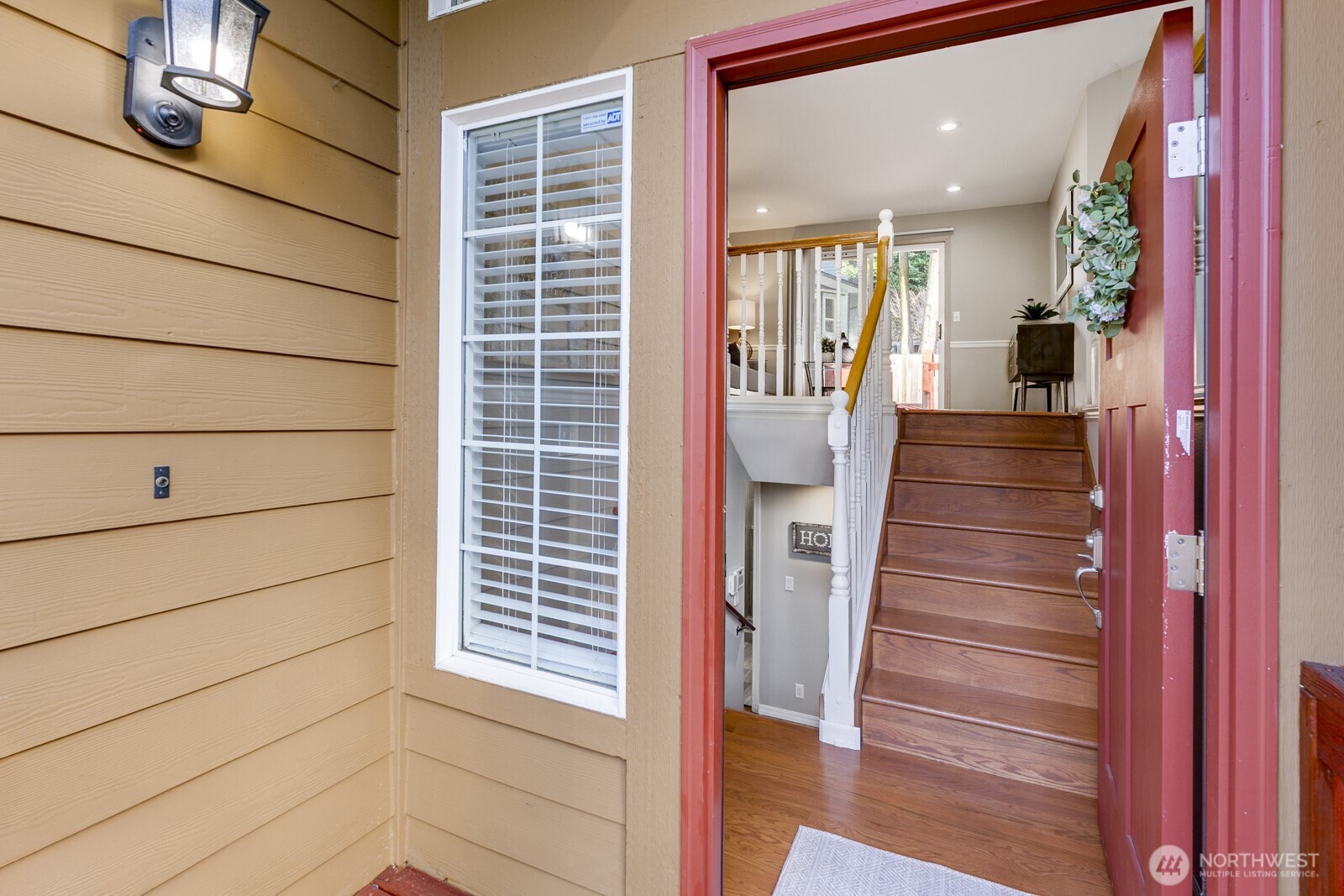 Inviting entry with gleaming hardwoods.