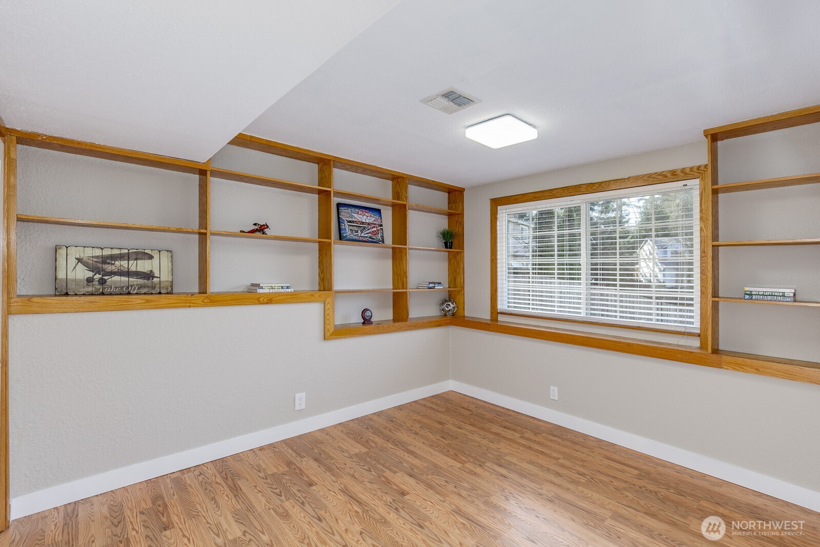 Sunny lower bedroom with lg closet and built-ins.