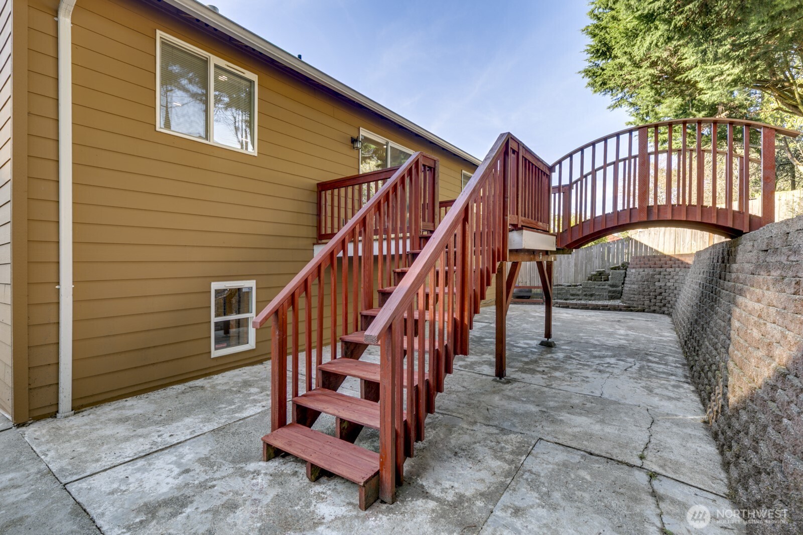 Impressive custom deck with charming bridge that leads to the upper yard.  Freshly stained and Perfect for barbecues and entertaining!