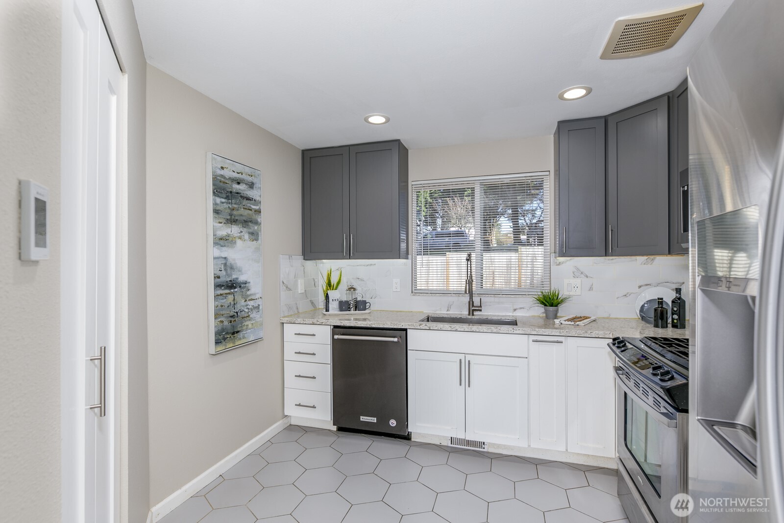 Quartz counters and backsplash plus soft close cabinets with accent lighting.