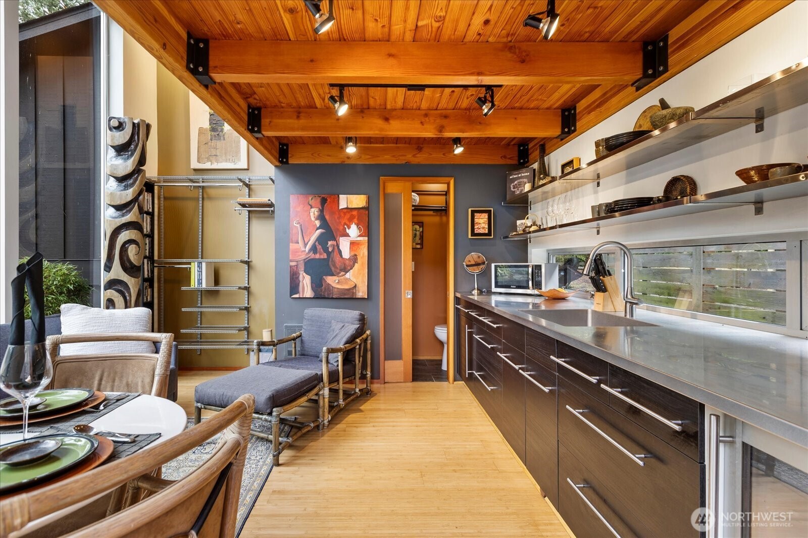 Exposed beams/ceiling, bamboo floors, sleek stainless prep surface for an ultra-efficient workspace, short-term rental potential, or guest quarters.