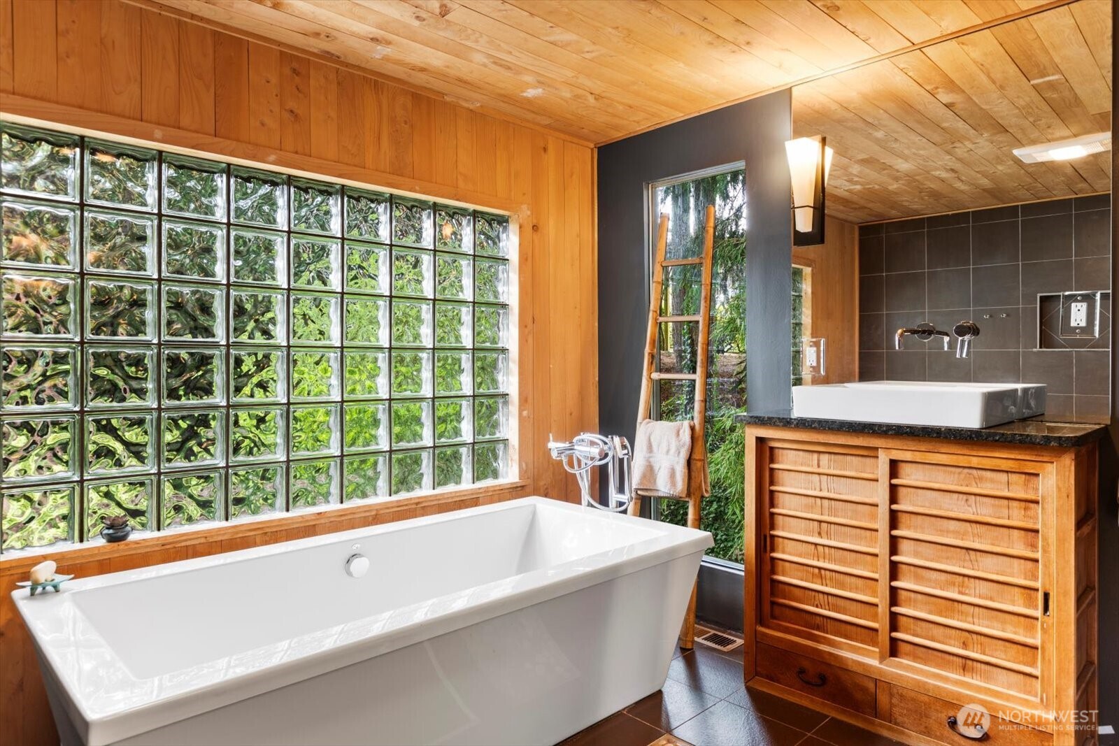 Primary bathroom features soaking tub, Hinoki white pine walls and ceilings, double rain shower, Tansu cabinetry, Italian fixtures, Toto toilet.