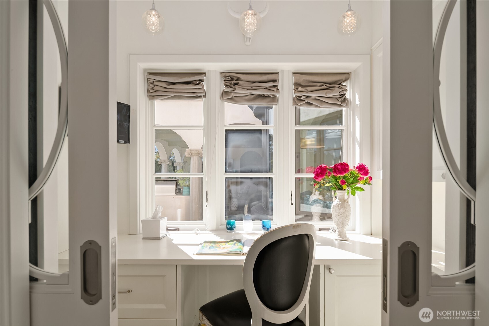 In the back hallway that leads to the kitchen is a small organization area (also with a great view!), and can be closed off with pocket doors.