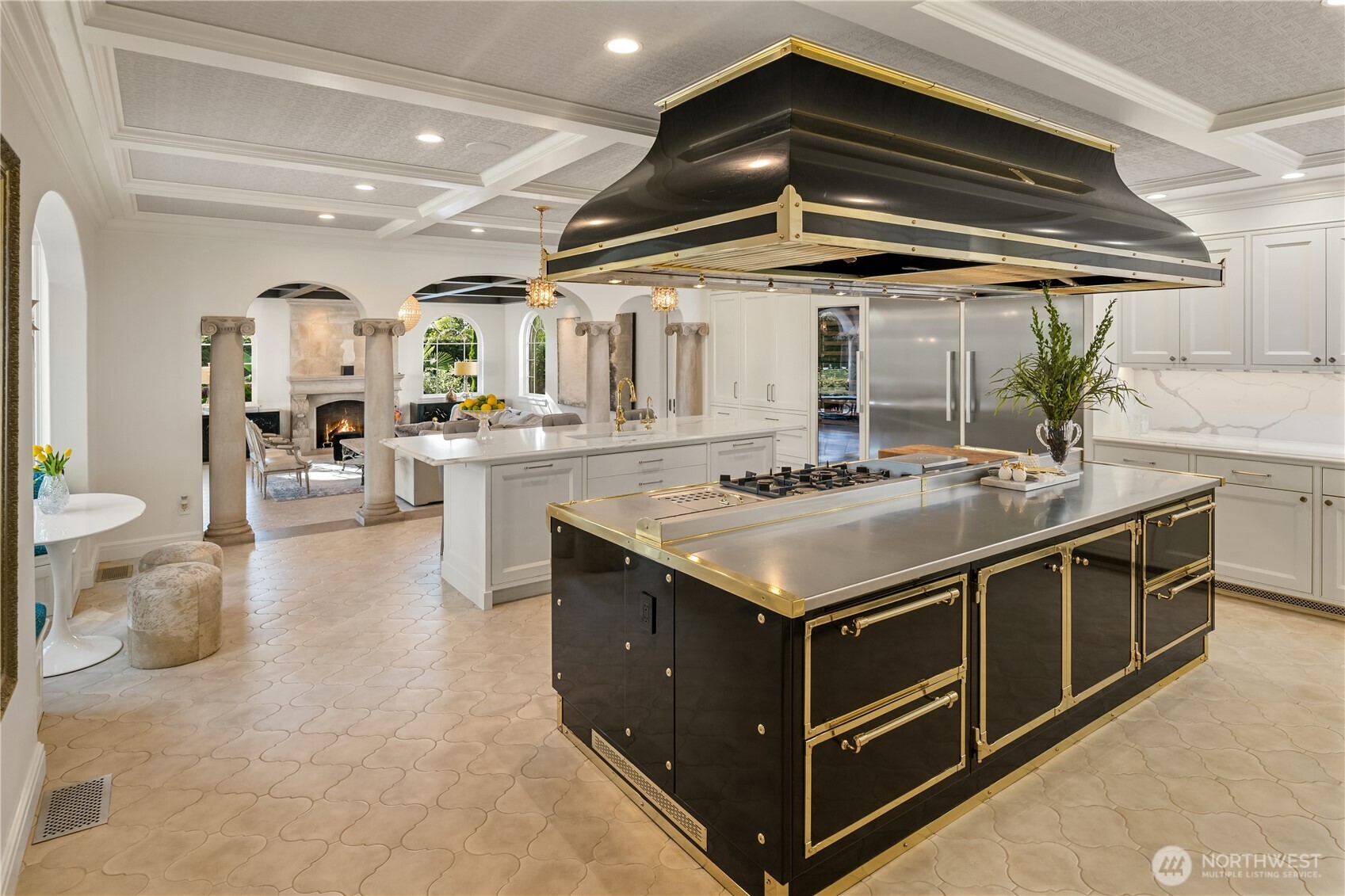 This is a first for me. I have never seen a Officine Gullo cooking island & commercial grade hood: 4 burners, induction station, griddle station, pasta/steamer station, prep area, convection oven, gas oven & warming area with 2 levels! Like a big lovely piece of jewelry for your kitchen! Also in the kitchen, an island for watching the cooking/TV while eating with room for 6 stools. Two Miele dishwashers, and a full size Miele refrigerator & freezer, 2 sinks, curved breakfast nook & so much more! Notice the adjoining family room through the archways....