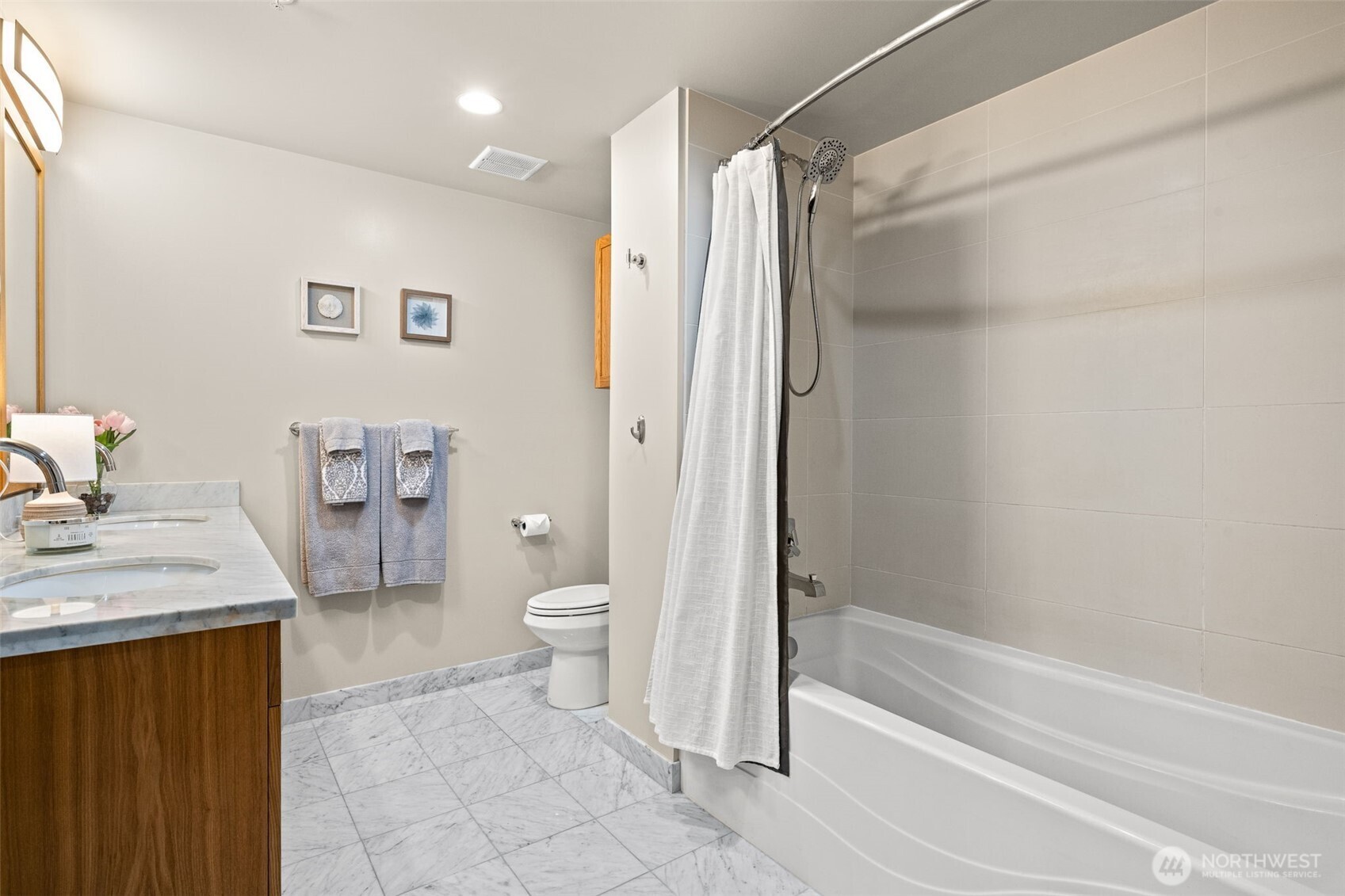 The bathroom features marble vanity and floors, plus a six foot soaking tub.