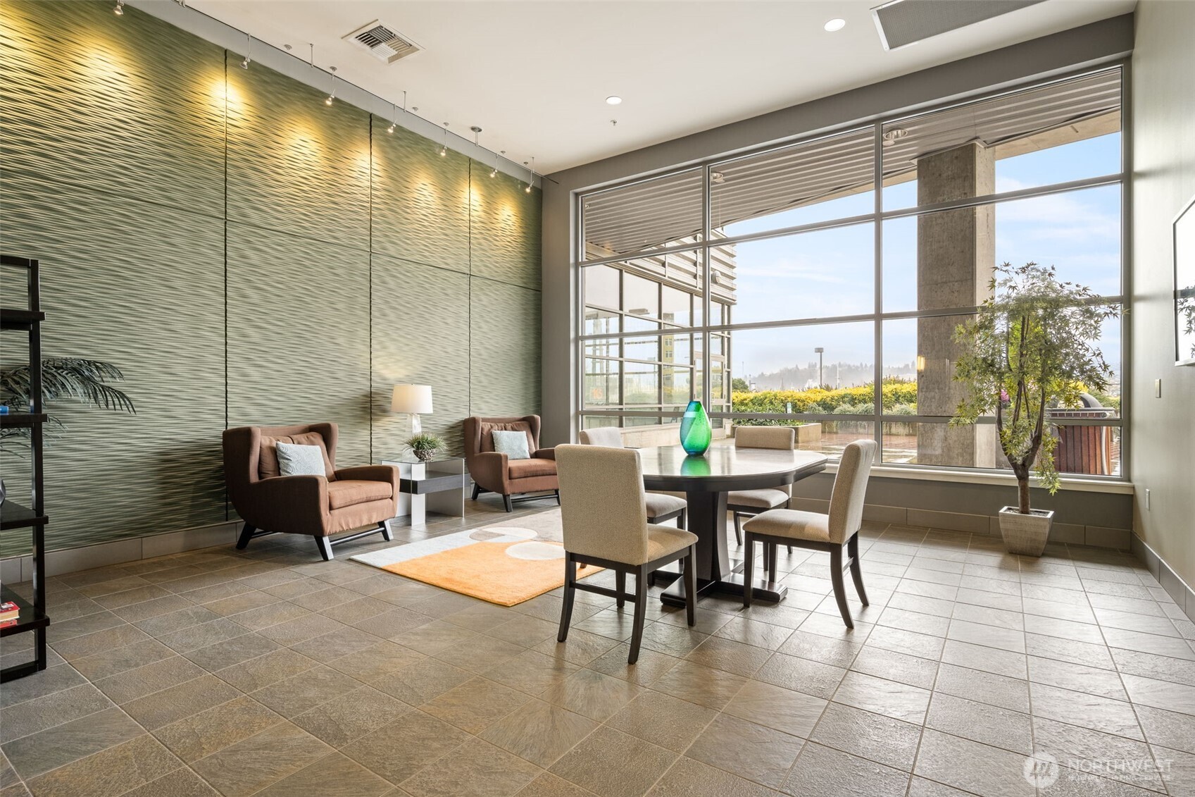 Here is a lobby retreat space with conference table and armchairs.